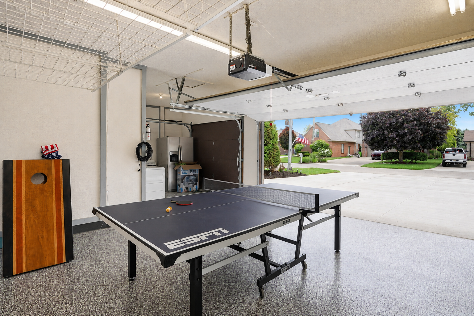 Spacious garage game lounge with ping pong table and open layout. Bright, clean, and versatile space perfect for entertainment, kids’ activities, or casual group hangouts with direct driveway access.