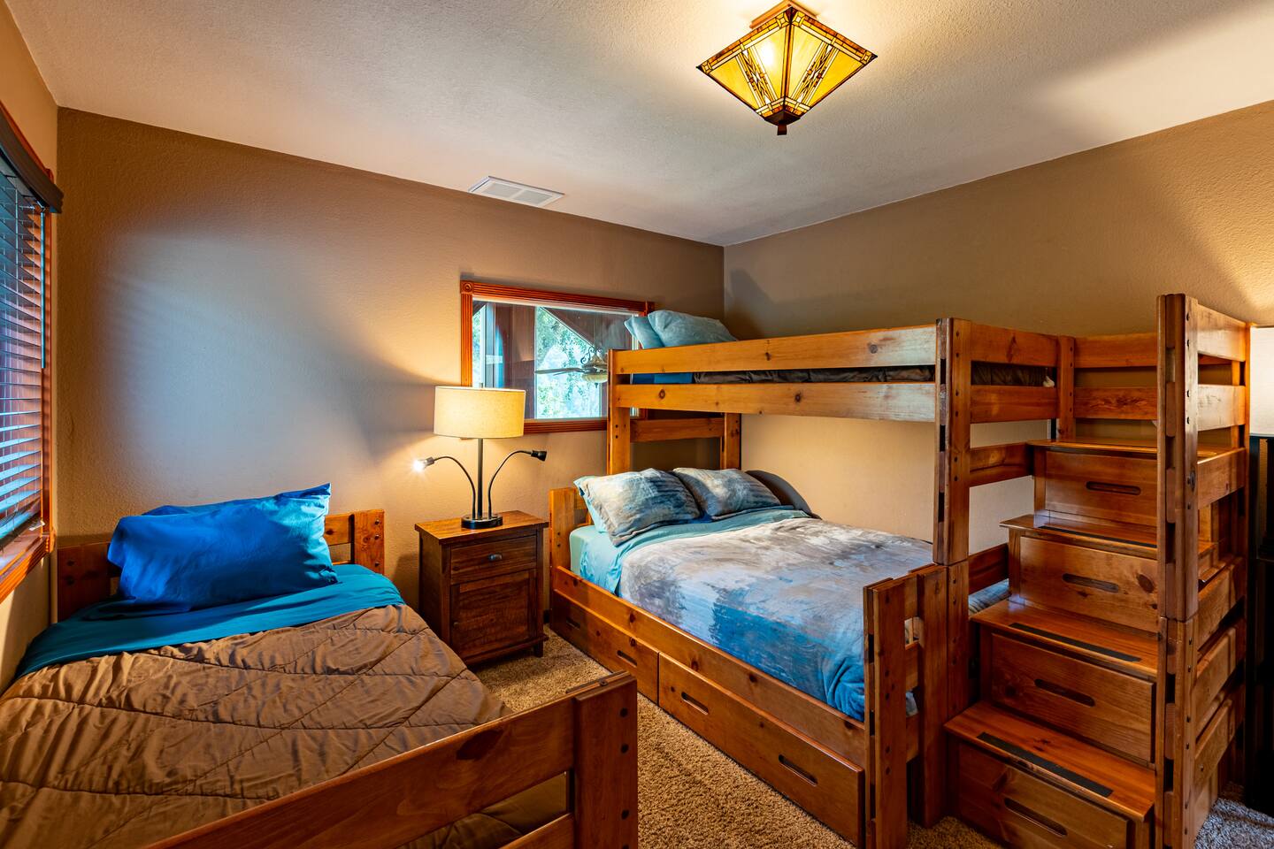 Third bedroom with single over full bunkbed and single bed