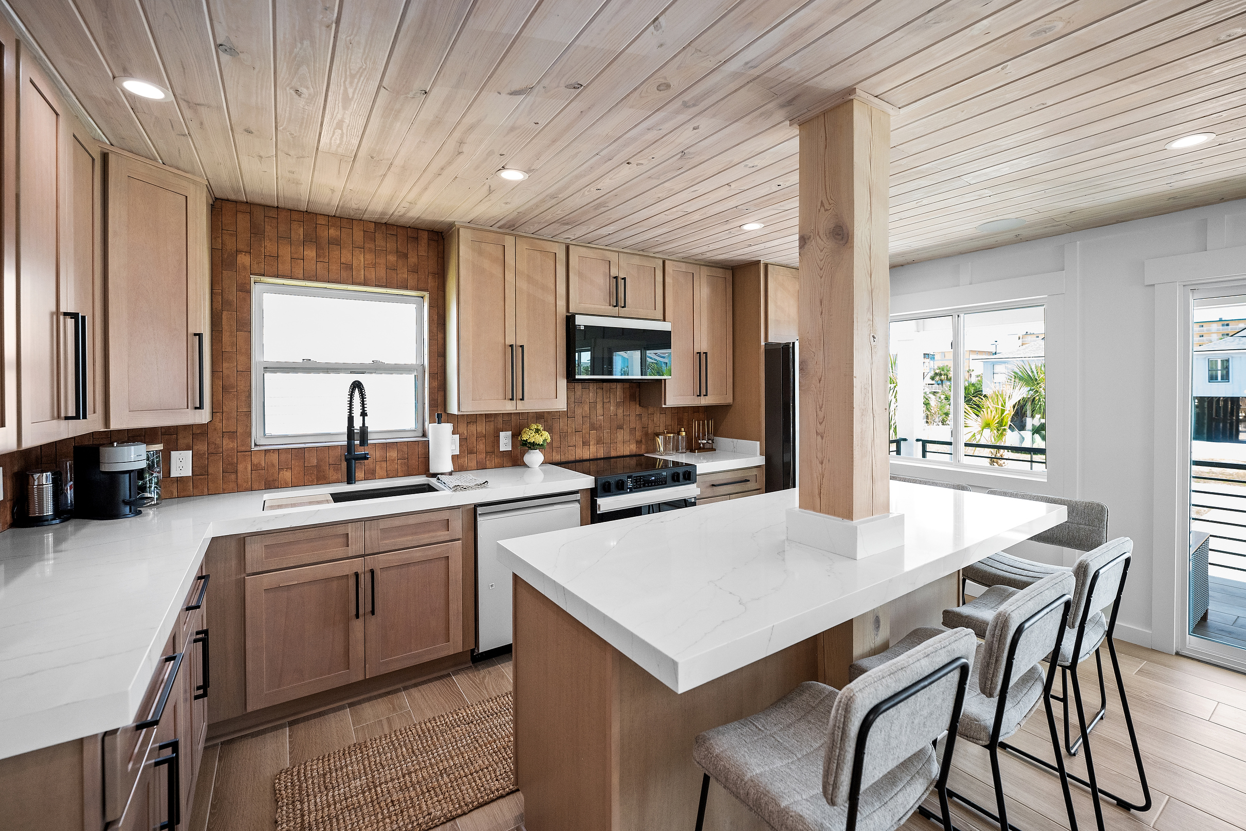 Another view of the full kitchen, generous cabinetry and oversized island.