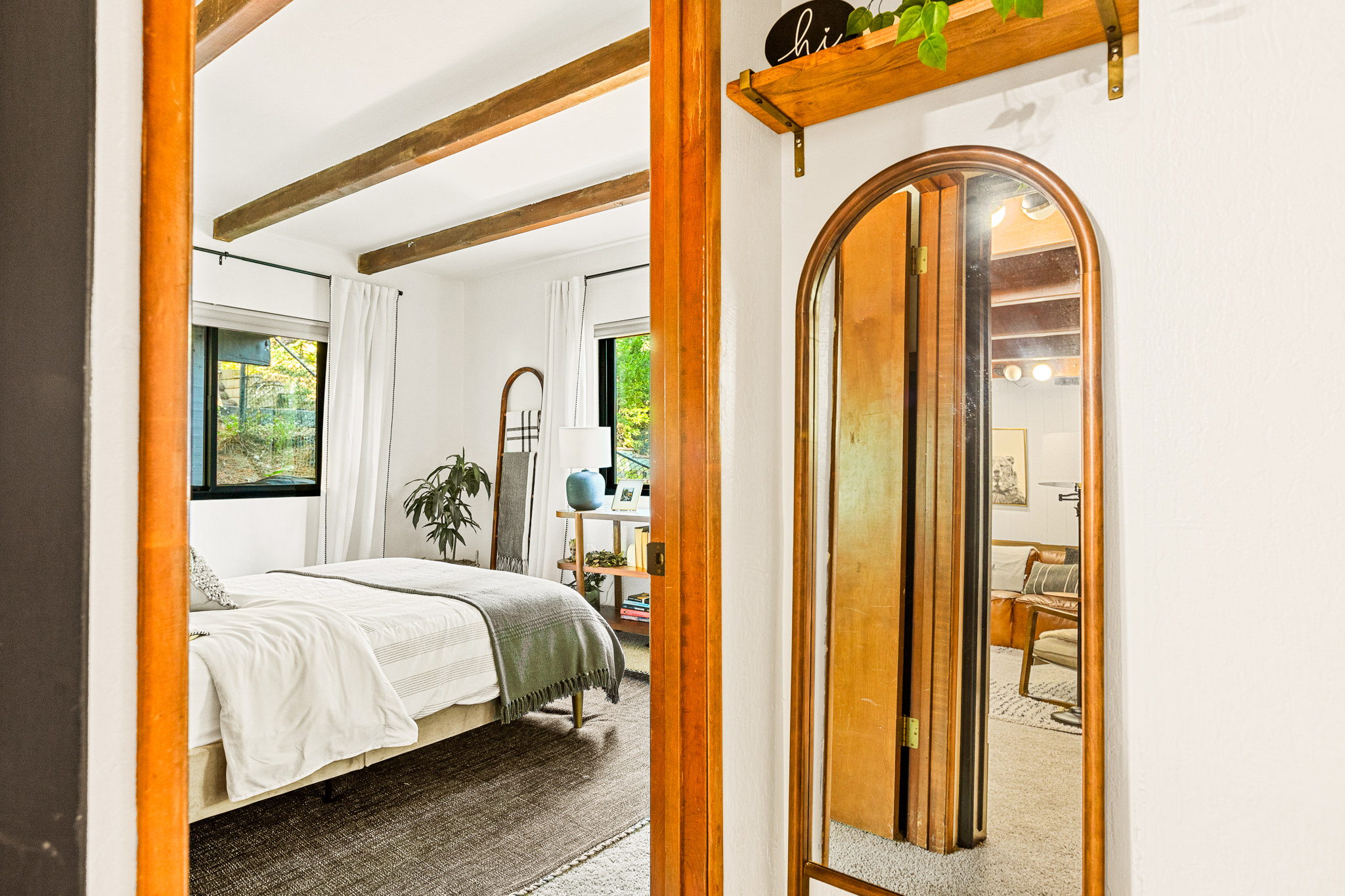Adjacent to the family room, you'll discover a beautiful bedroom, offering a peaceful haven to rest your head after an inspiring day in Lake Arrowhead.