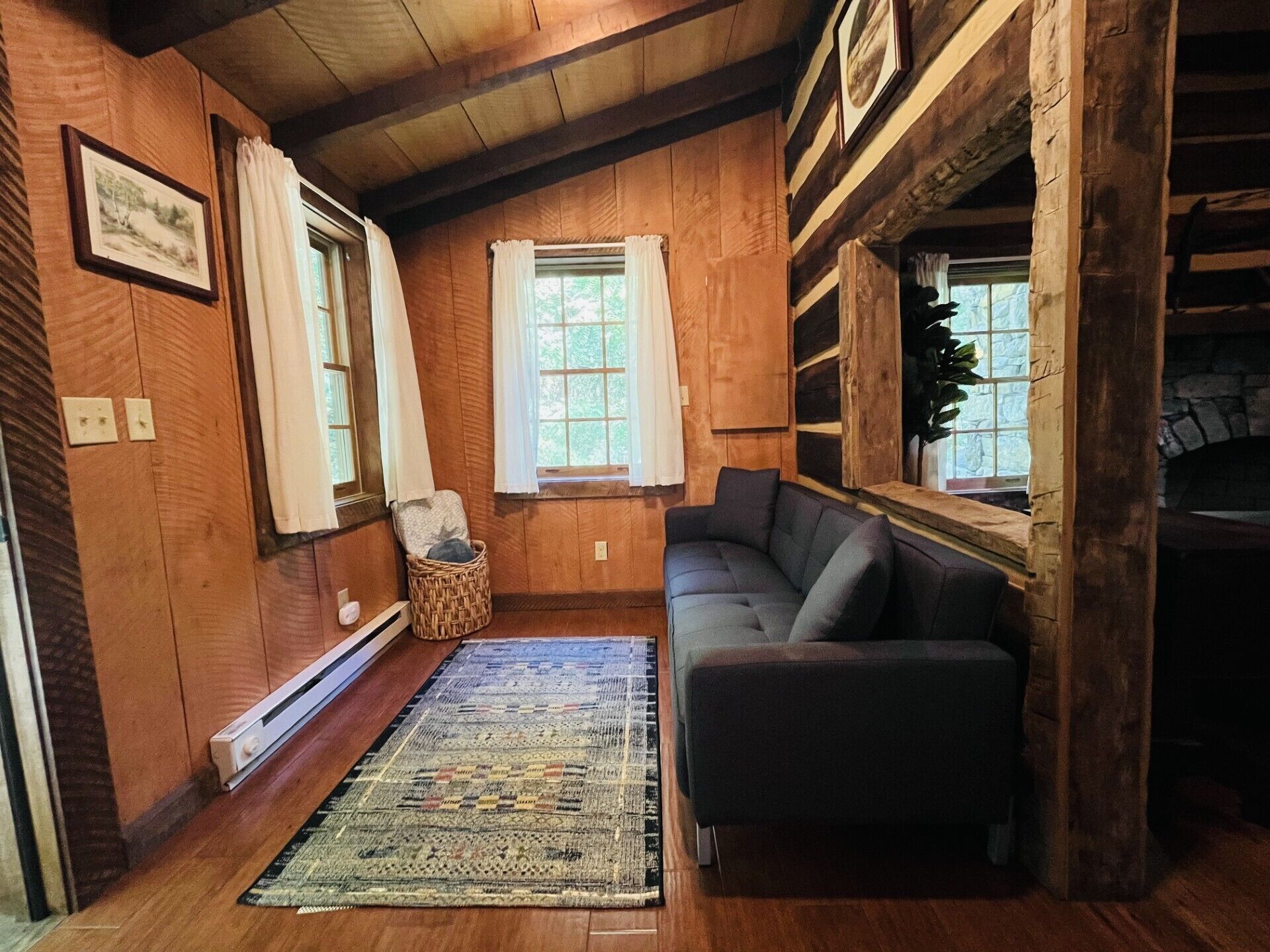 Linens for the sleeping couch are in the basket in the corner.