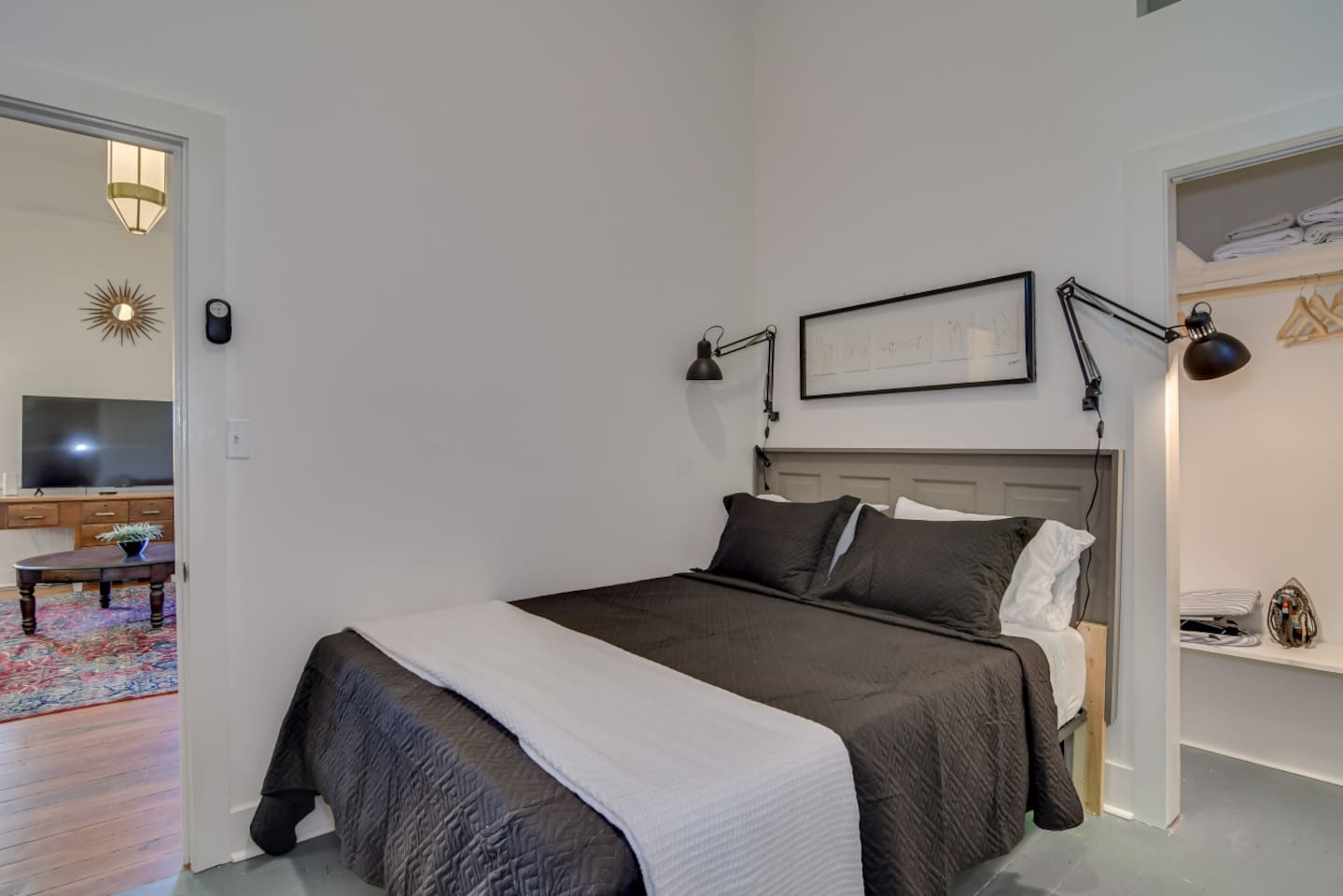 Guest bedroom with cozy queen bed, room darkening shades and a TV