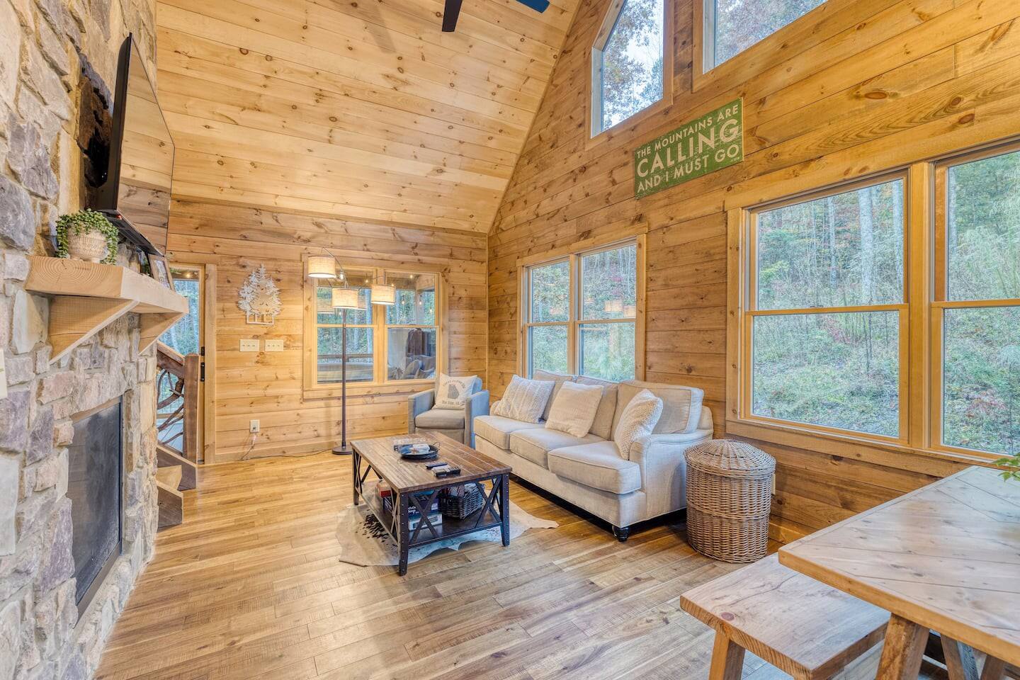 Inside our cabin, plush seating beckons by the indoor fireplace, creating a snug retreat where warmth and relaxation intertwine seamlessly.