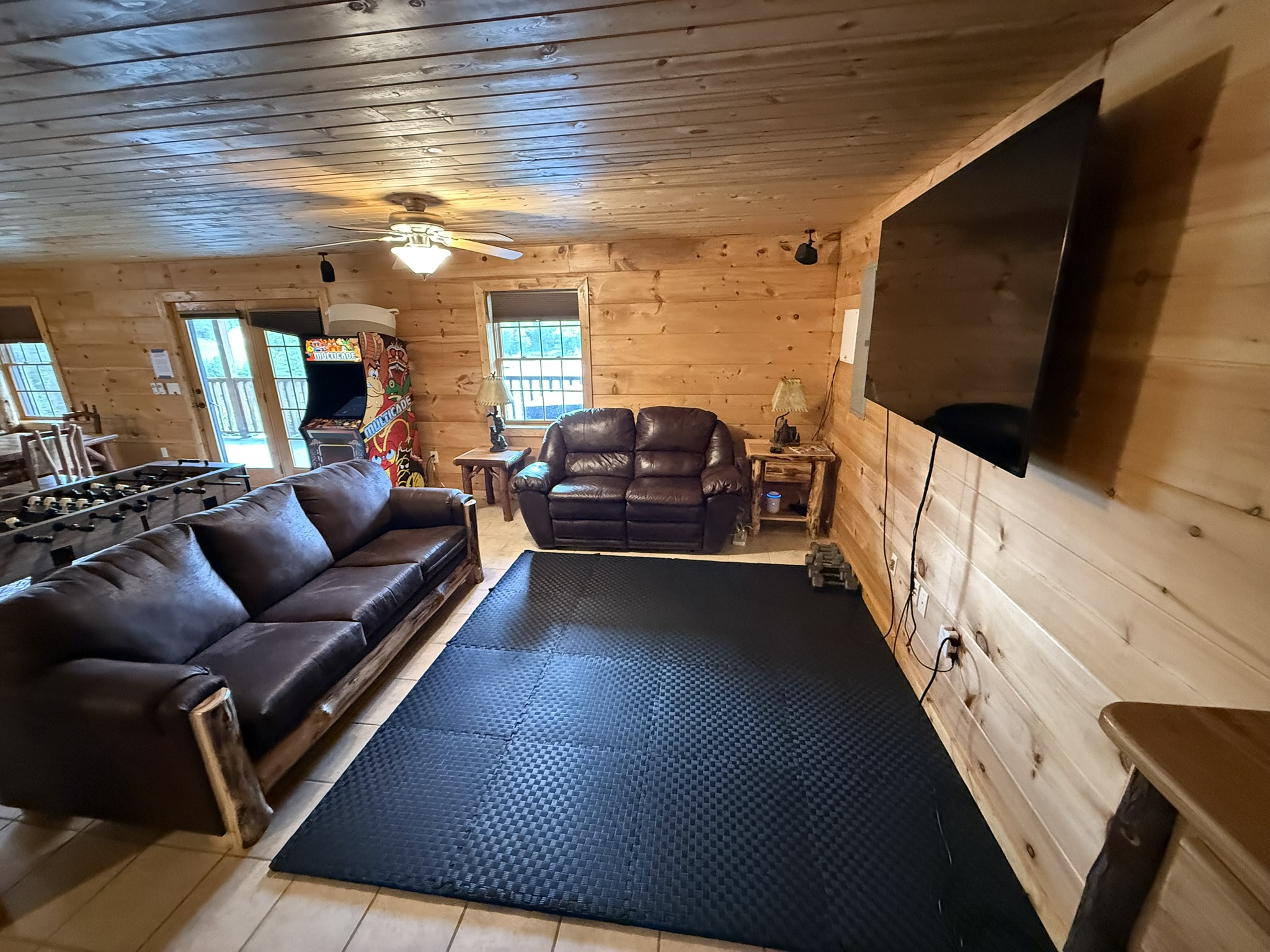 Very Large  Screen Smart TV, 2 sofas (one is a sleeper sofa) with cushioned exercise mat