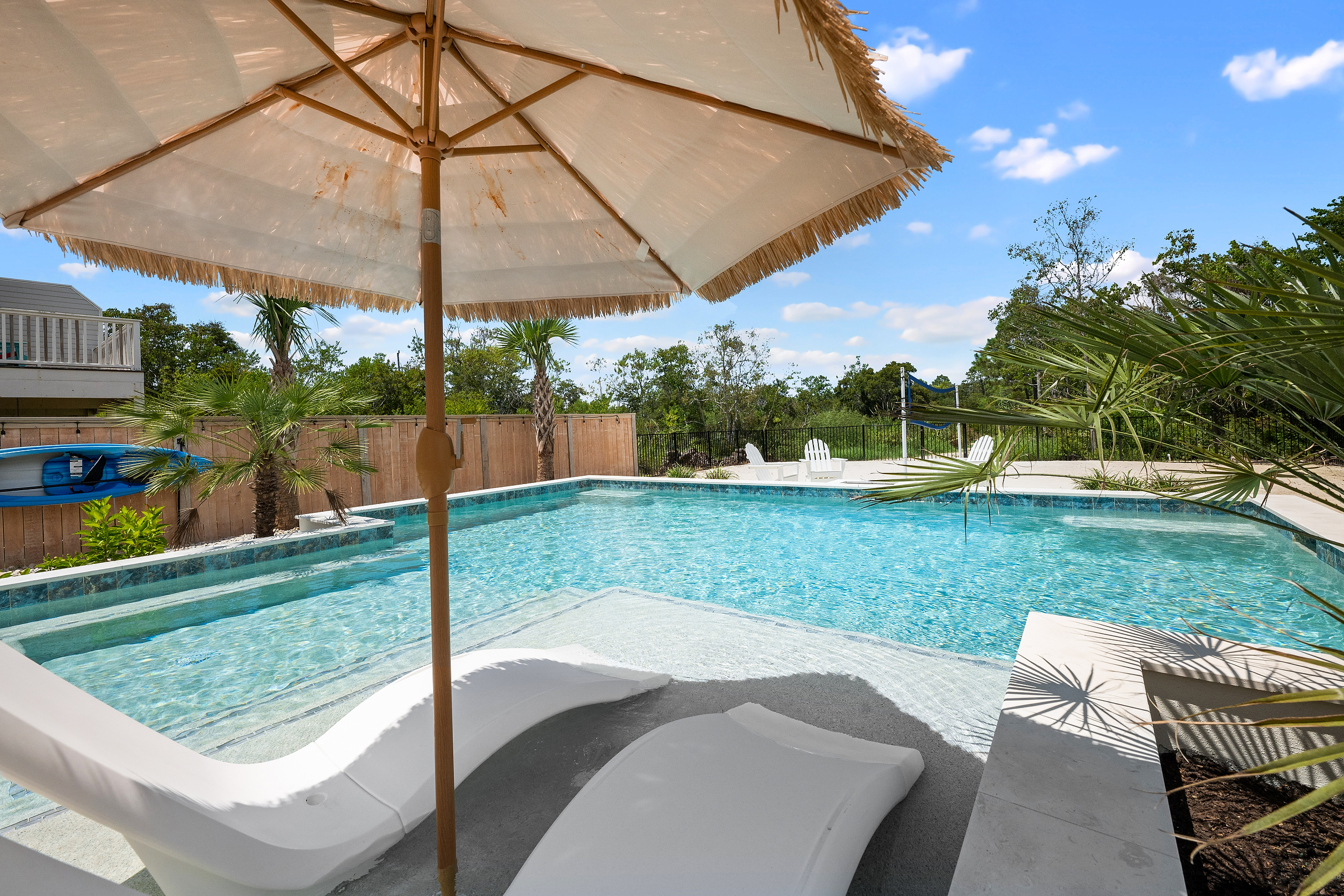 A shaded poolside spot for relaxing while the family swims.