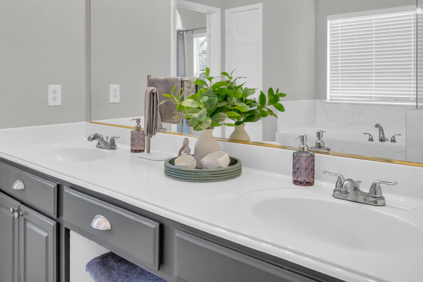 Spacious en suite bathroom with a large soaking tub, separate walk-in shower, double sinks, ample counter space, and guest-ready bath essentials.