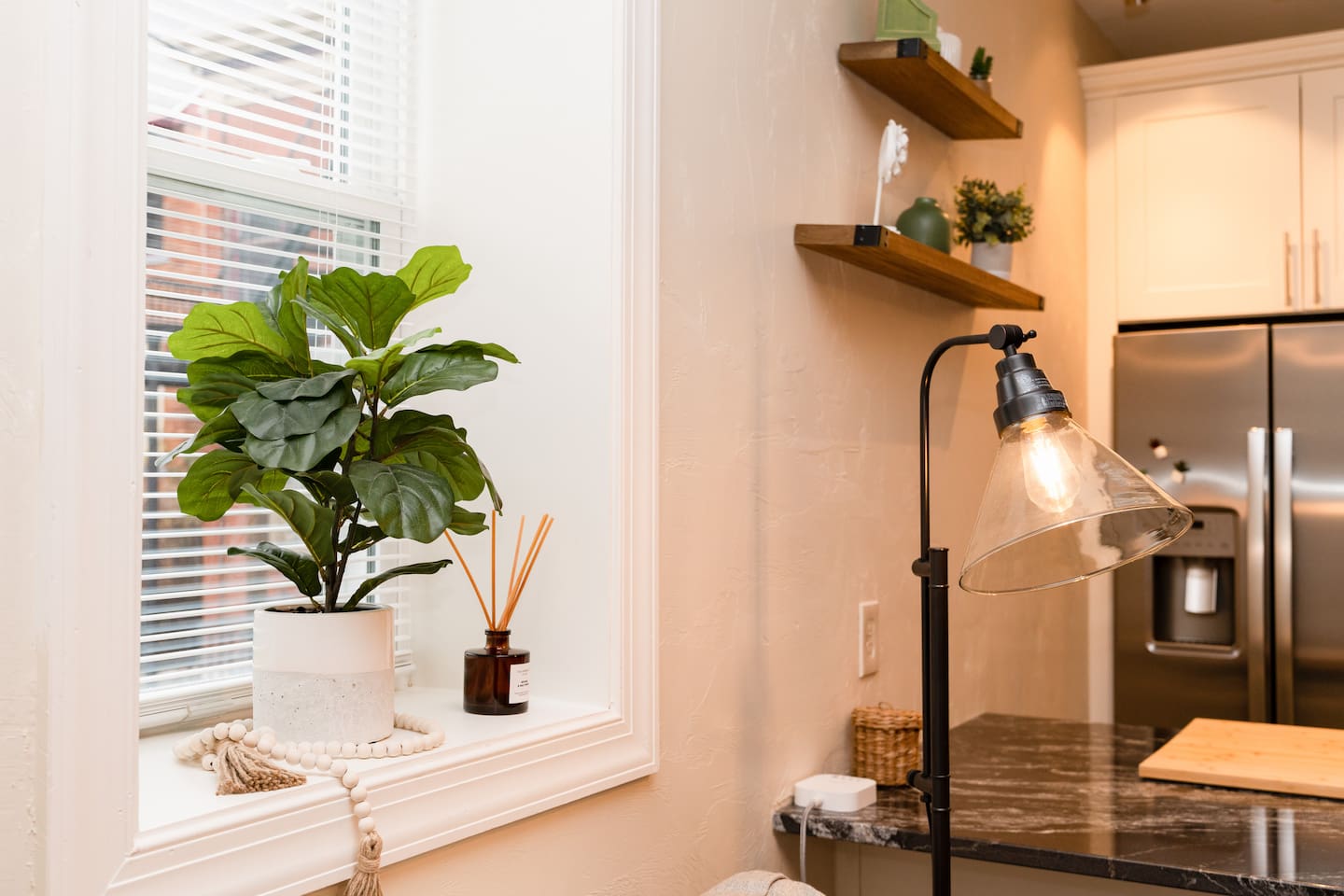 Bright living area window with a cozy lamp, creating a warm and inviting atmosphere.