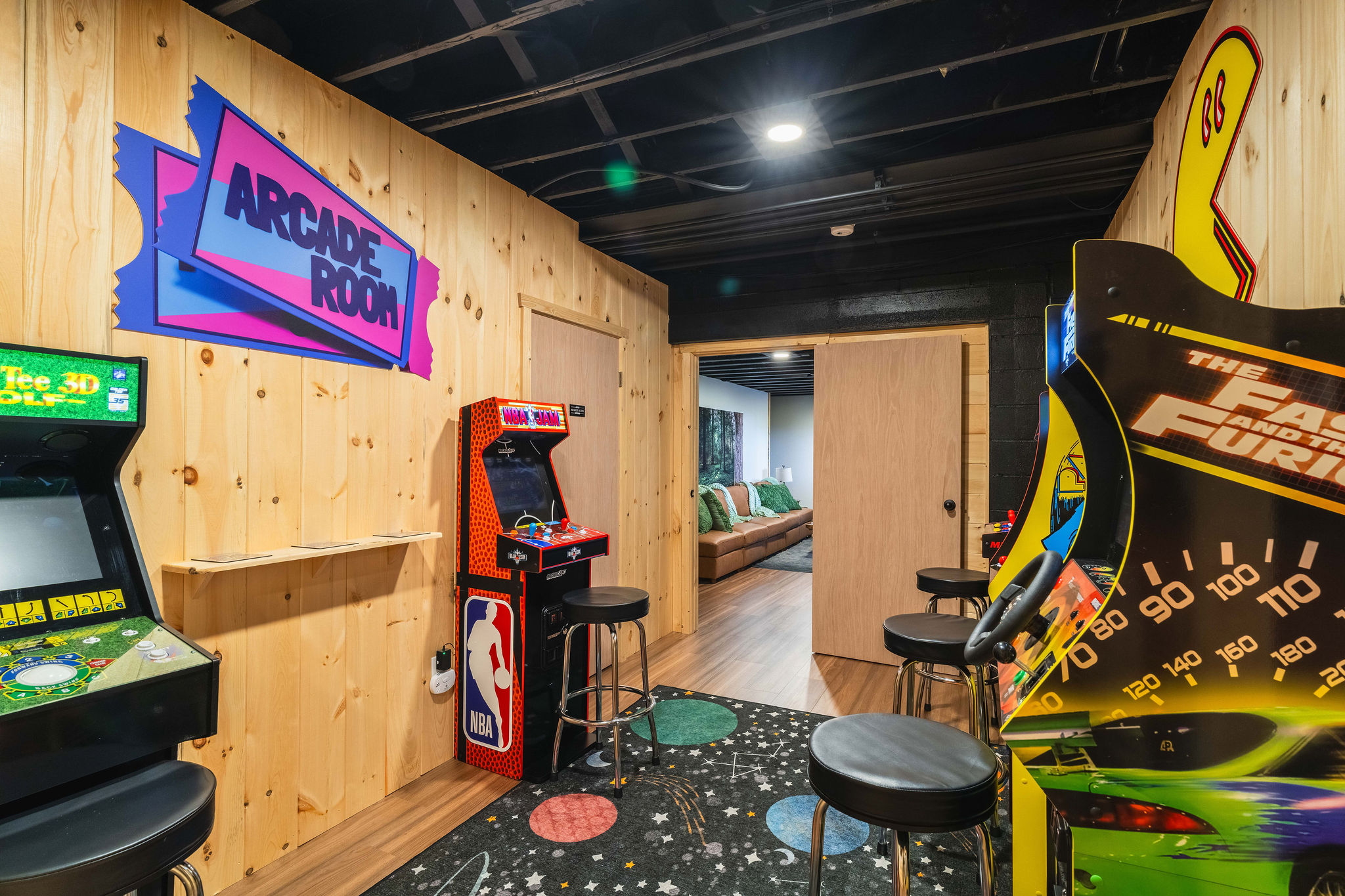 🎮 Five full-size arcade cabinets, steps from the second living room and the game lounge.