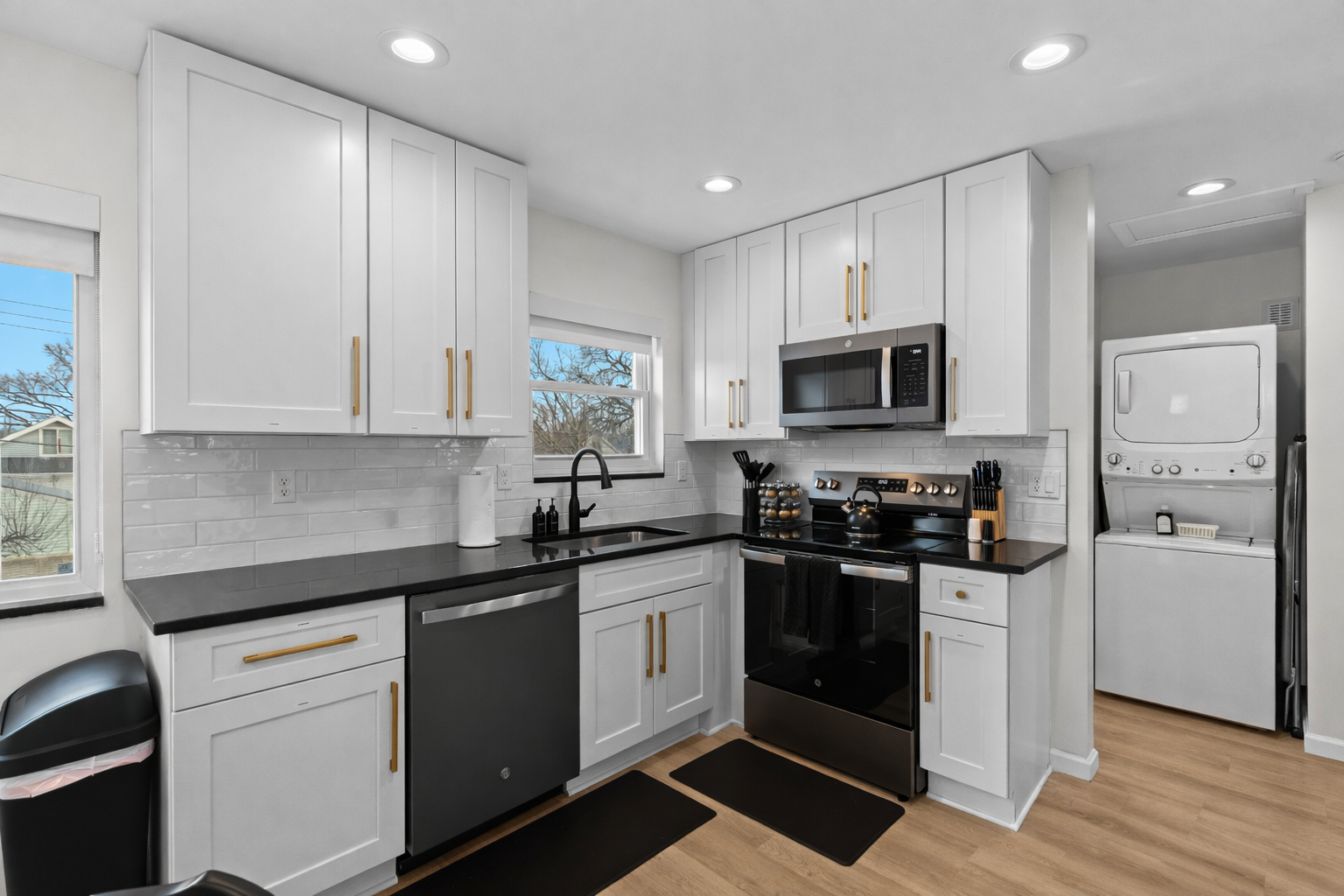 Bright, modern kitchen with sleek appliances, ample cabinetry, and in-unit laundry—ideal for cooking comfortably and enjoying longer stays.