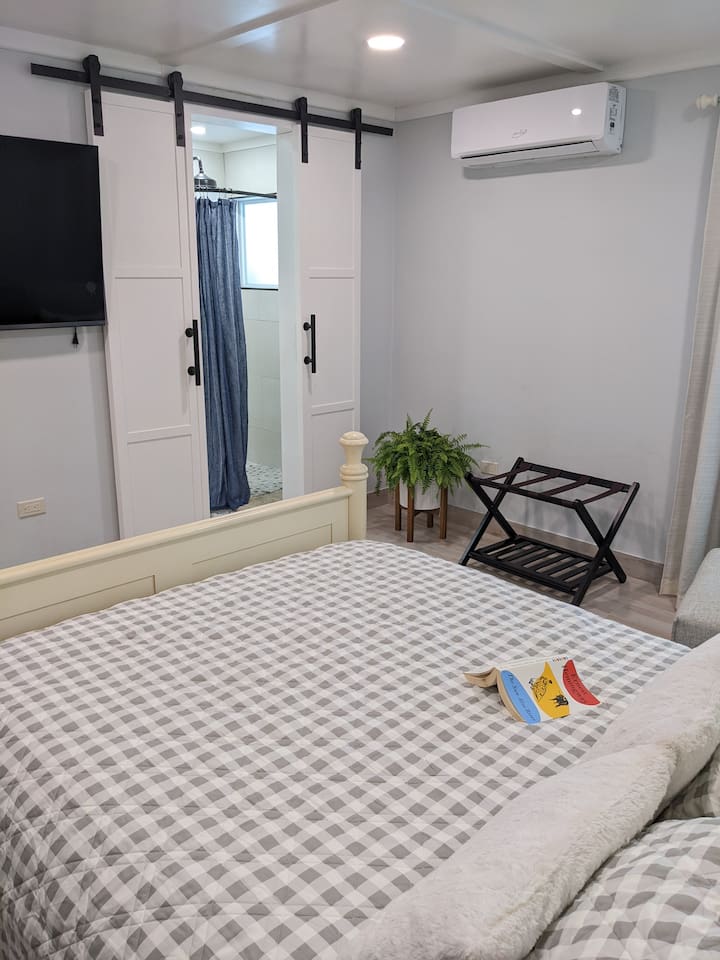 This is the view of the 2nd bedroom on the 1st level. Since this picture was taken we added a makeup table/desk where the luggage rack is. This queen bed is VERY comfortable! The bed is also adjustable(in case you want to raise it to read).