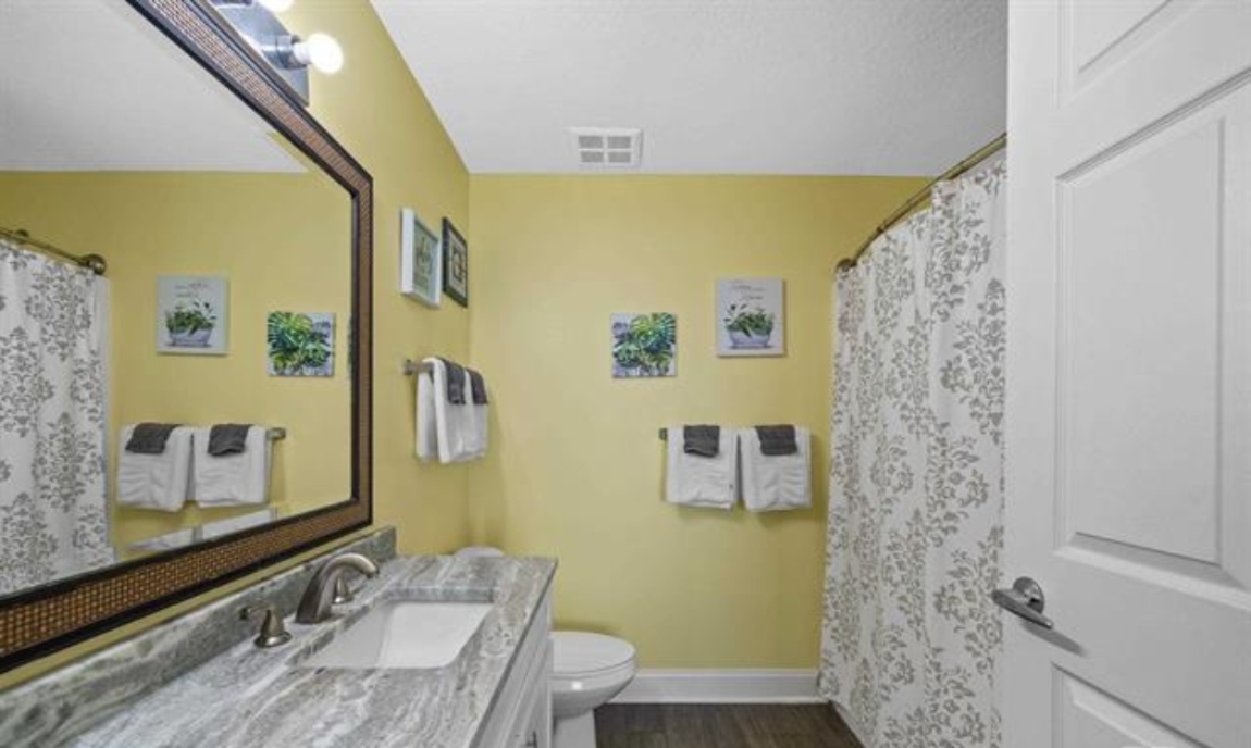 Ensuite bathroom with vanity and tub/shower combo