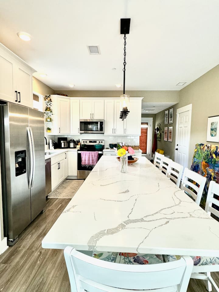 Extended counter - extra seating and work spaceCounter stools with cushionsGlass top electric range and microwaveFull size fridgeFull pantryKeurig and drip coffee makersInstant water heaterToasterBlender
