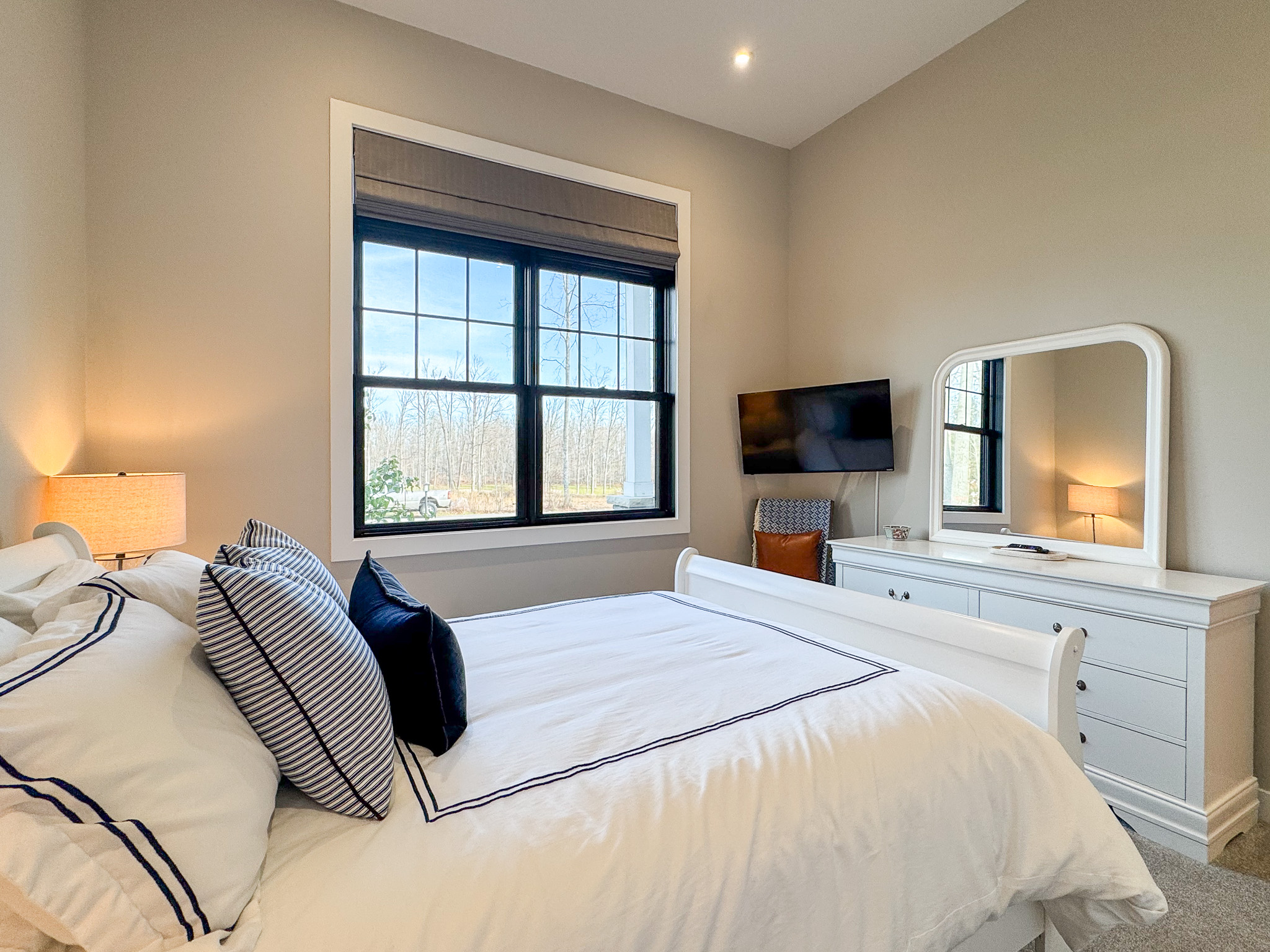 Guest bedroom with queen bed and tv with streaming.