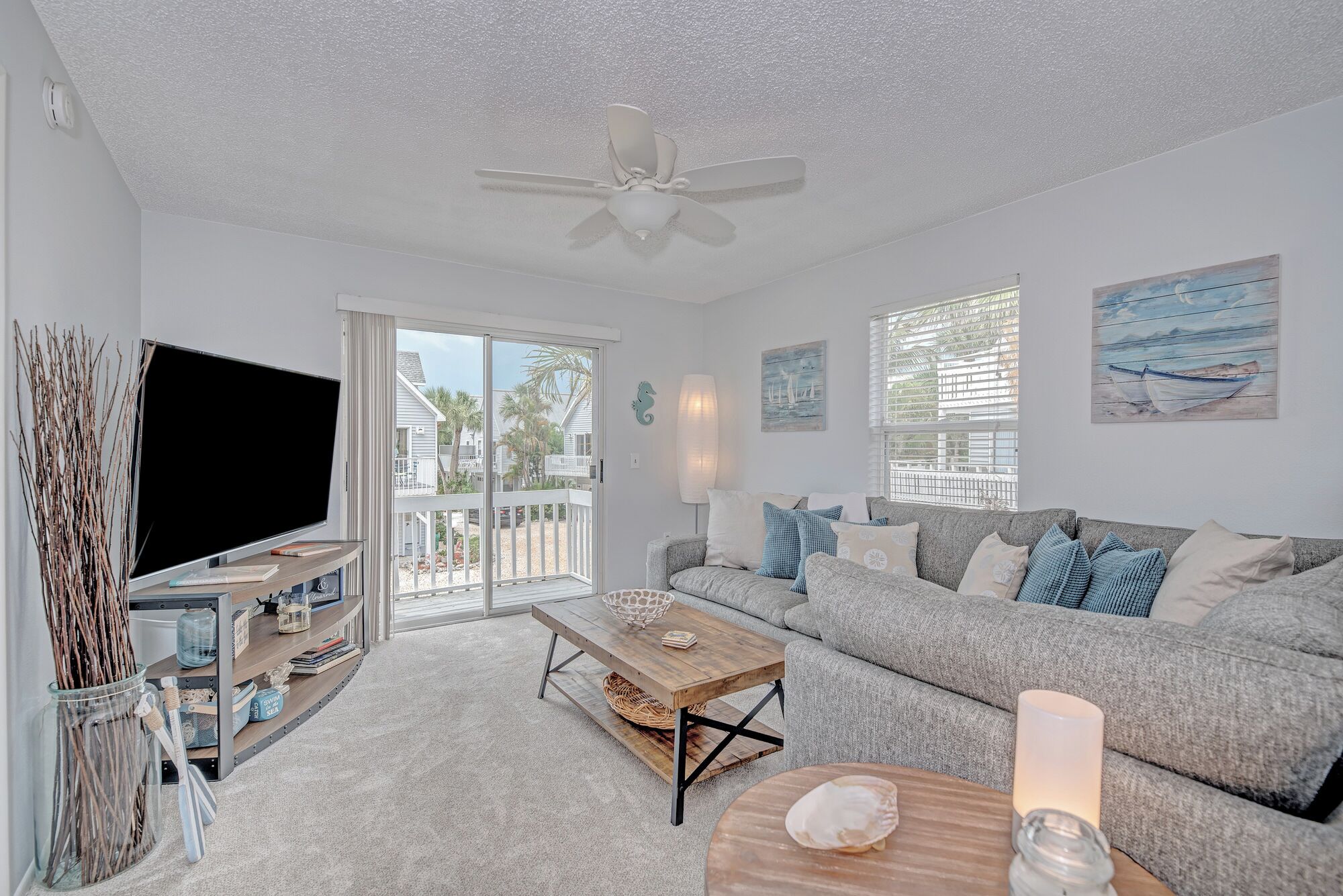 Open, airy layout with comfy seating, smart TV and outdoor front deck area. 