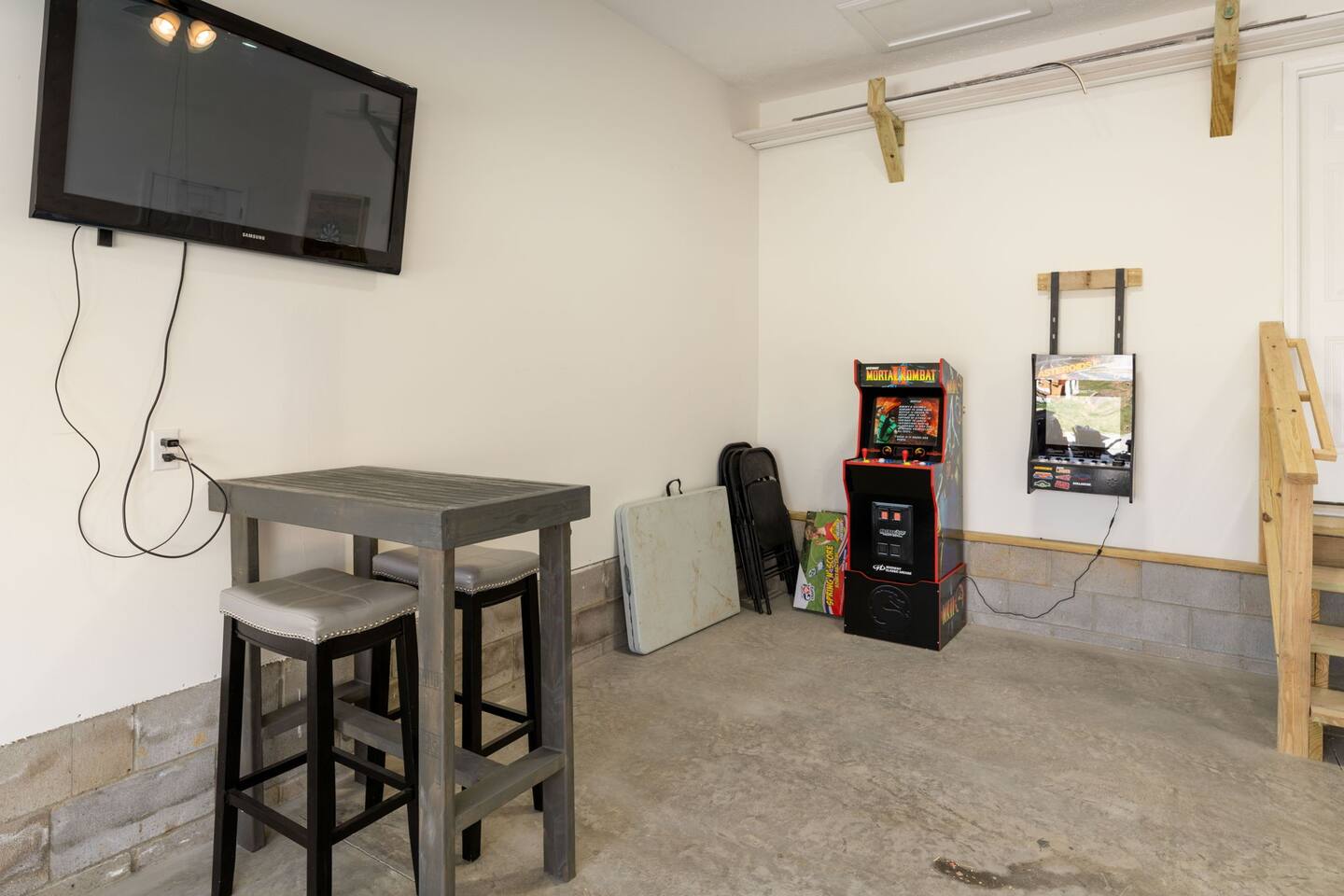 entertainment garage. featuring ping pong, putt putt, darts, tv, arcade games, basketball. Also outdoor games such as cornhole boards, chipping game, etc.