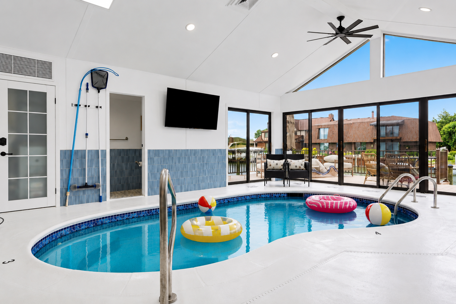 Relax and enjoy year-round swimming in this bright indoor heated pool, featuring vaulted ceilings, skylights, and a spacious open design ideal for both lounging and entertaining.