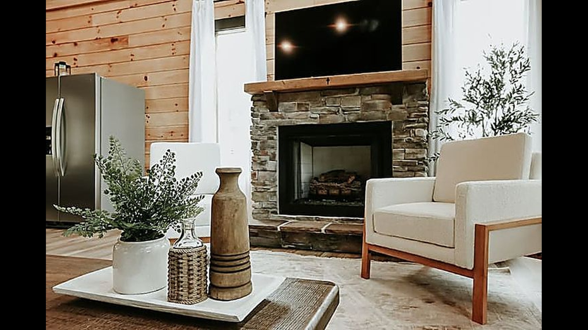 Cozy up in the living room where soft lighting, warm wood, and a crackling fire make every night feel special