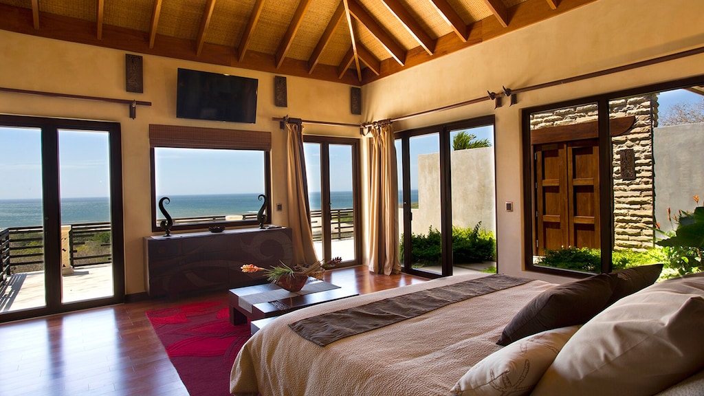 Master bedroom unspoiled ocean views through out .