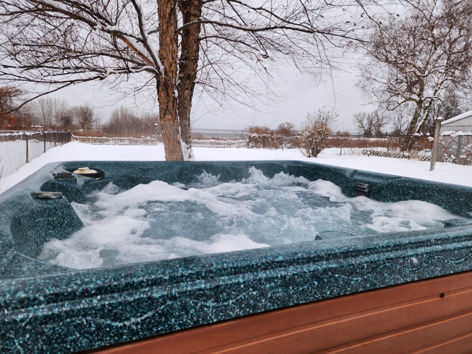 Relax in the private hot tub with a view of Lake Muskegon