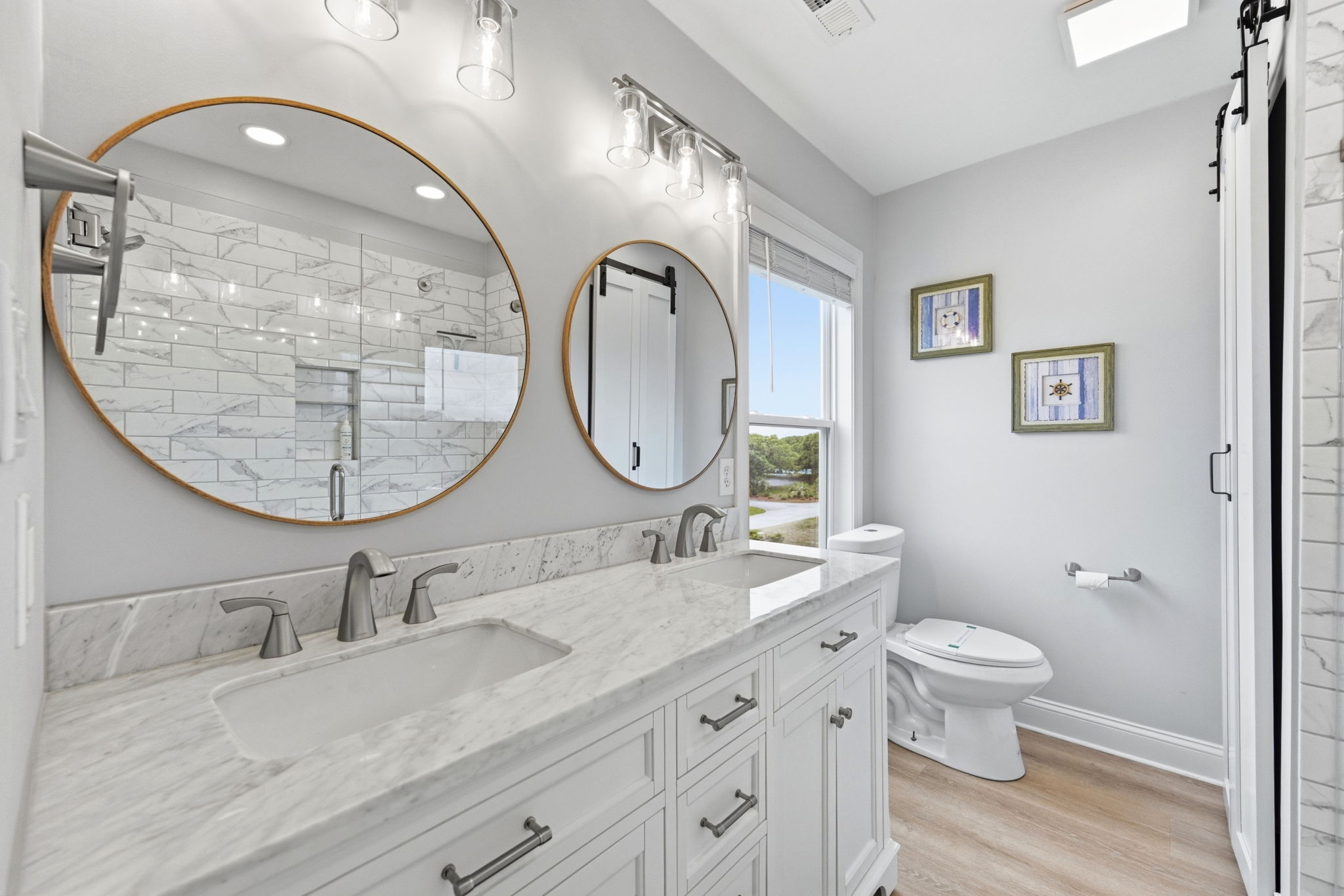 Bright, updated bathroom with his-and-hers sinks for added convenience