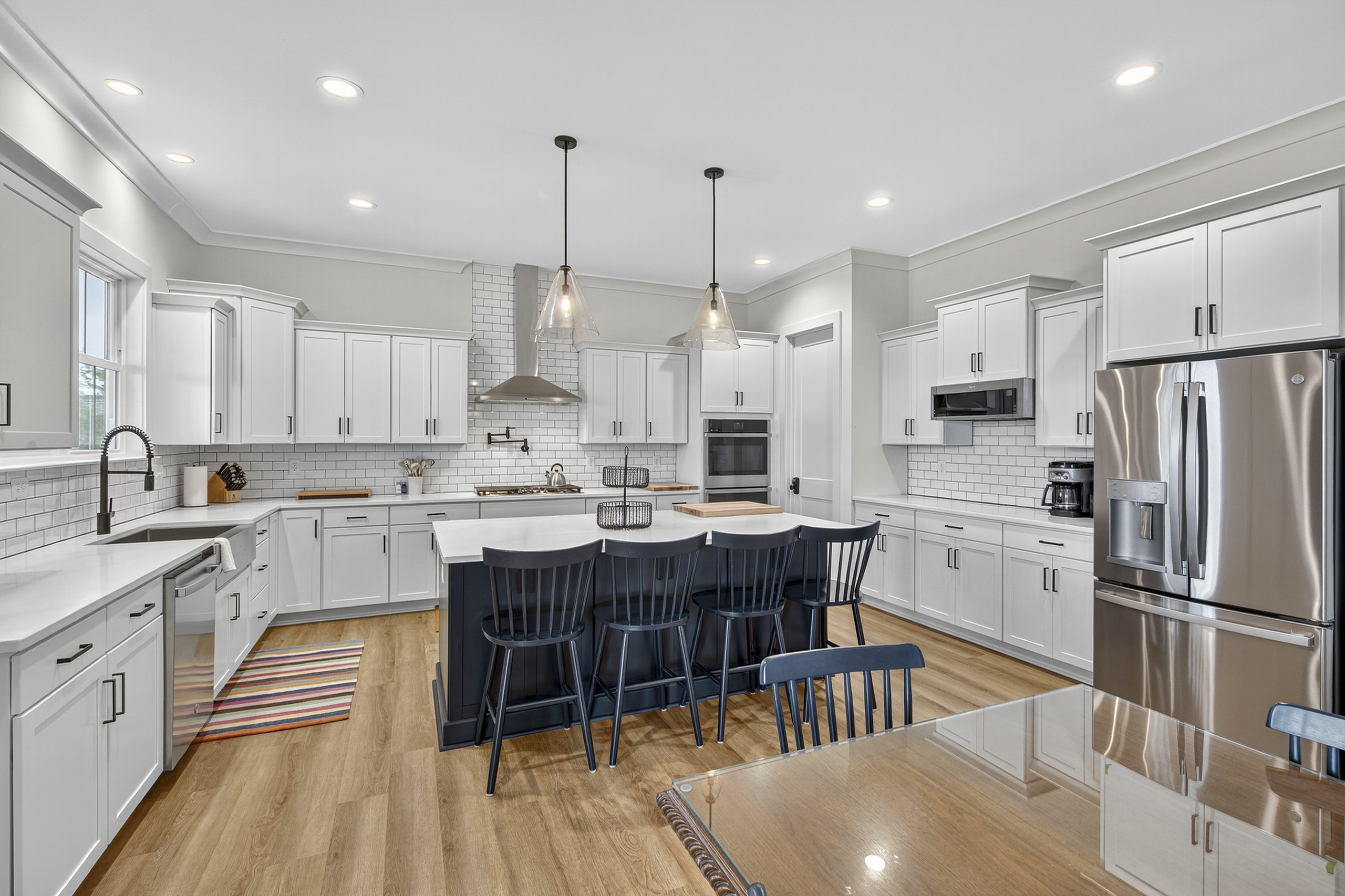 Beautiful and bright kitchen with breakfast bar seating and views of the lake—perfect for morning coffee or evening snacks.