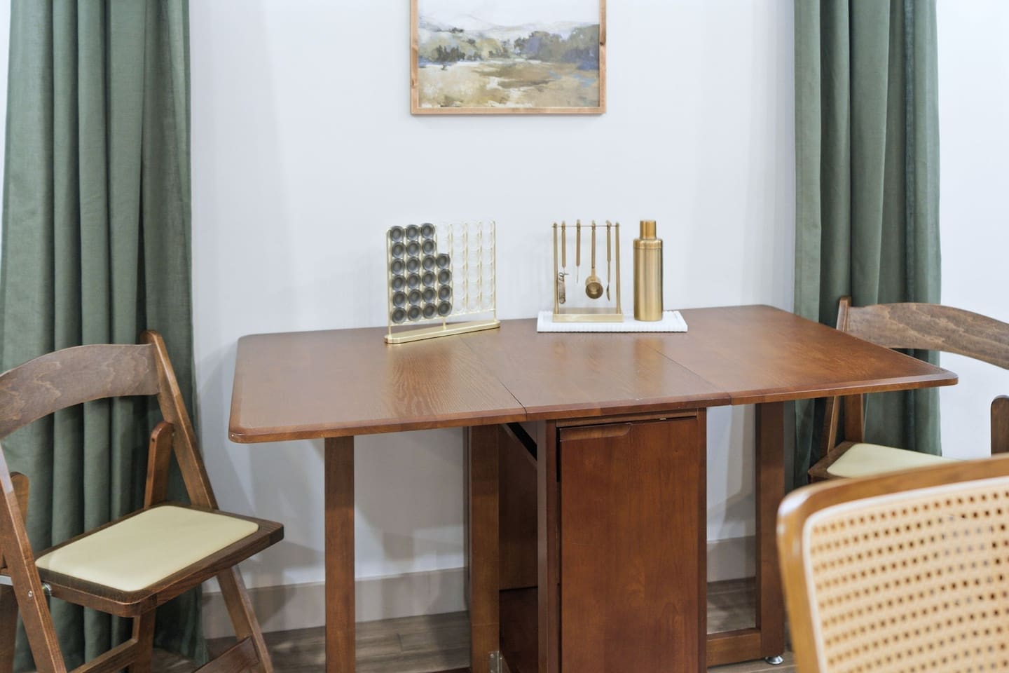 Another view of the cozy dining area featuring a wooden table, comfortable seating, and stylish décor for relaxed meals at home.