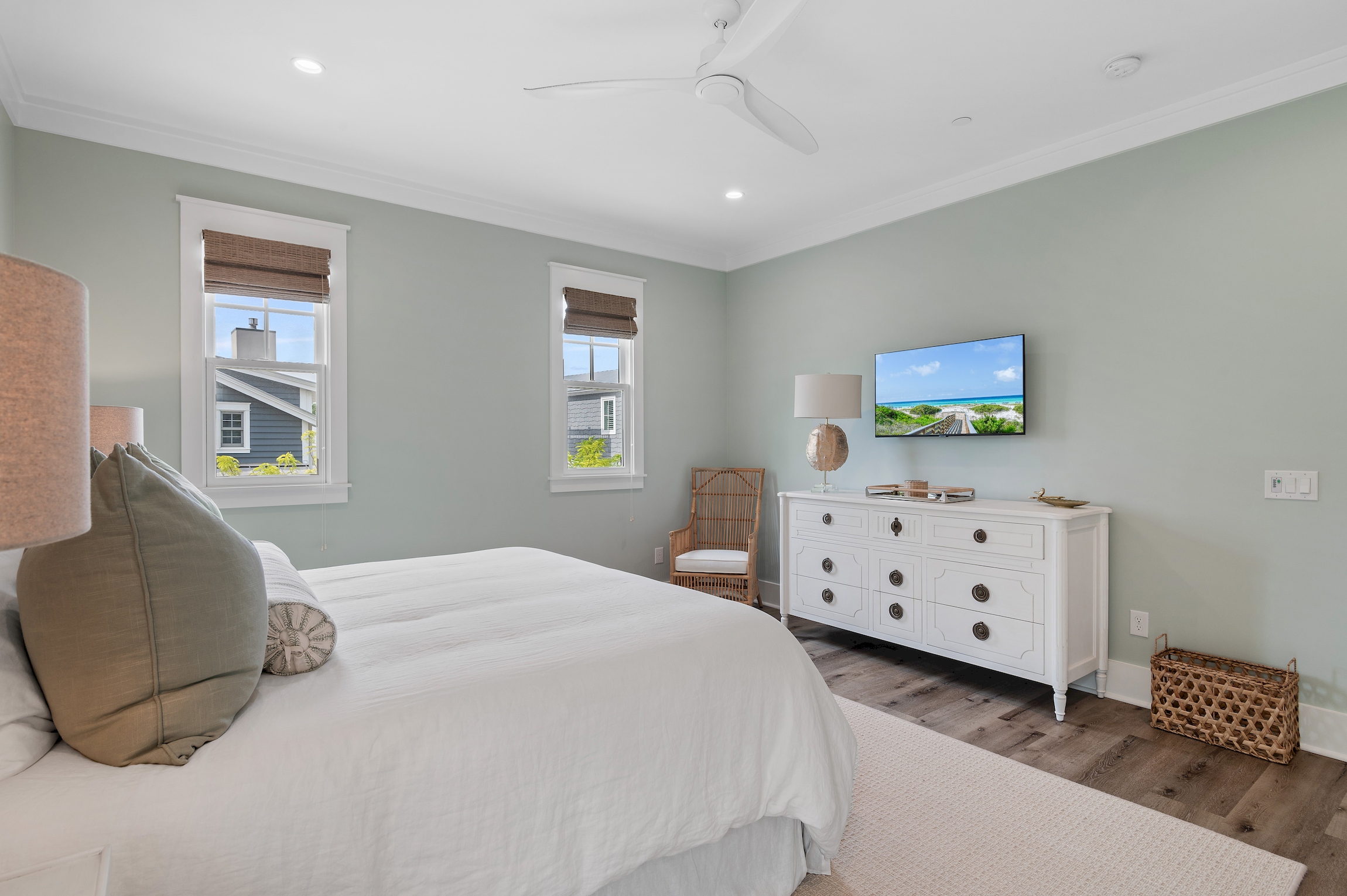 A large dresser has plenty of room to put away all of your clothes, and the wall mounted TV is perfect for streaming your favorite show.