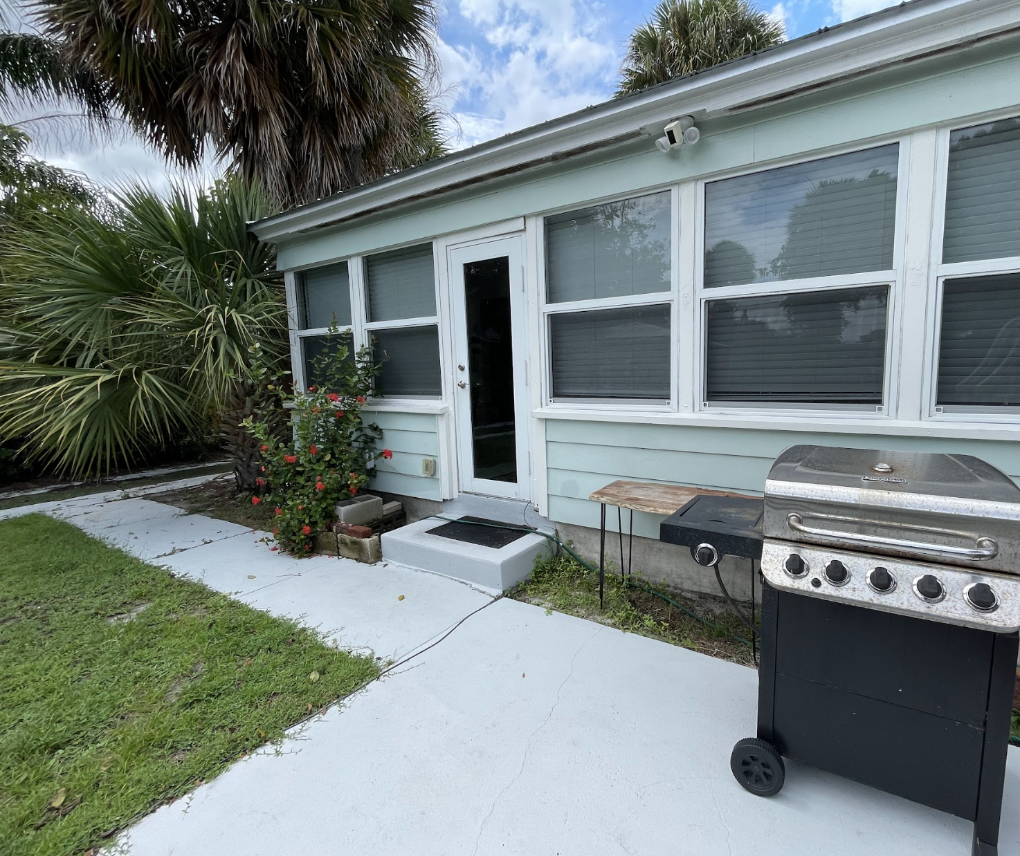 Just off the "Florida Room" is the back patio, featuring a grill, lap pool and seating area.
