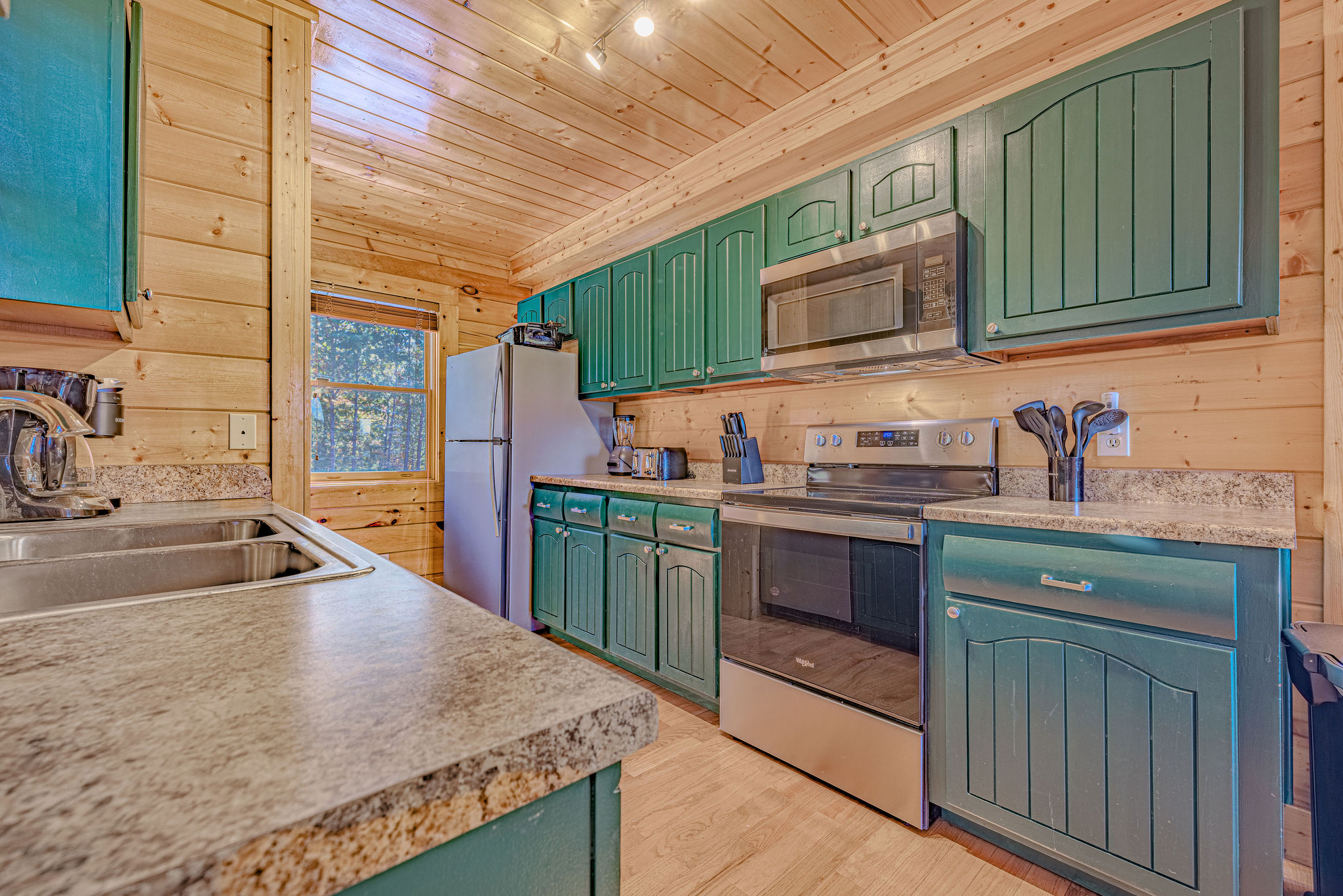 Fully stocked kitchen to cook your favorite meals. Cabinets recently updated to an emerald green color.