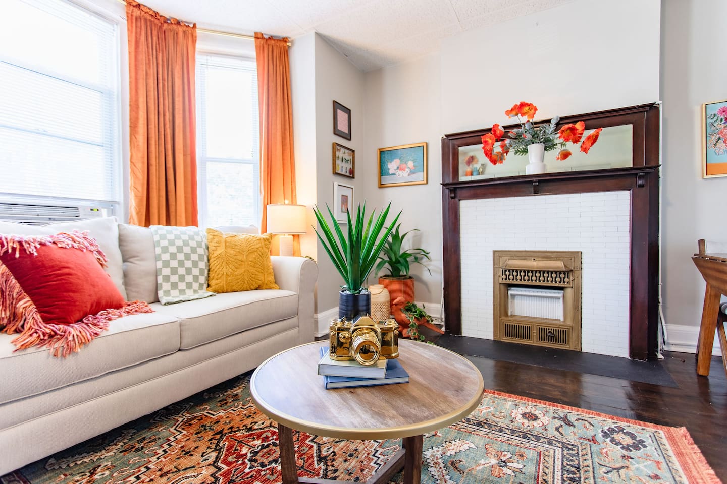 Charming living room with a comfortable couch, a stylish center table, and tasteful furniture that adds a touch of elegance and warmth to the space, making it perfect for relaxation or entertaining.