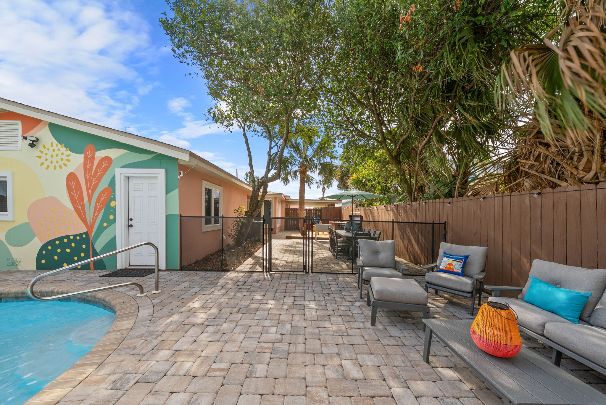 Step outside and take it all in. The full backyard gives you pool on one side, hammock lounge on the other, and a mural backdrop that
guests photograph every single stay.