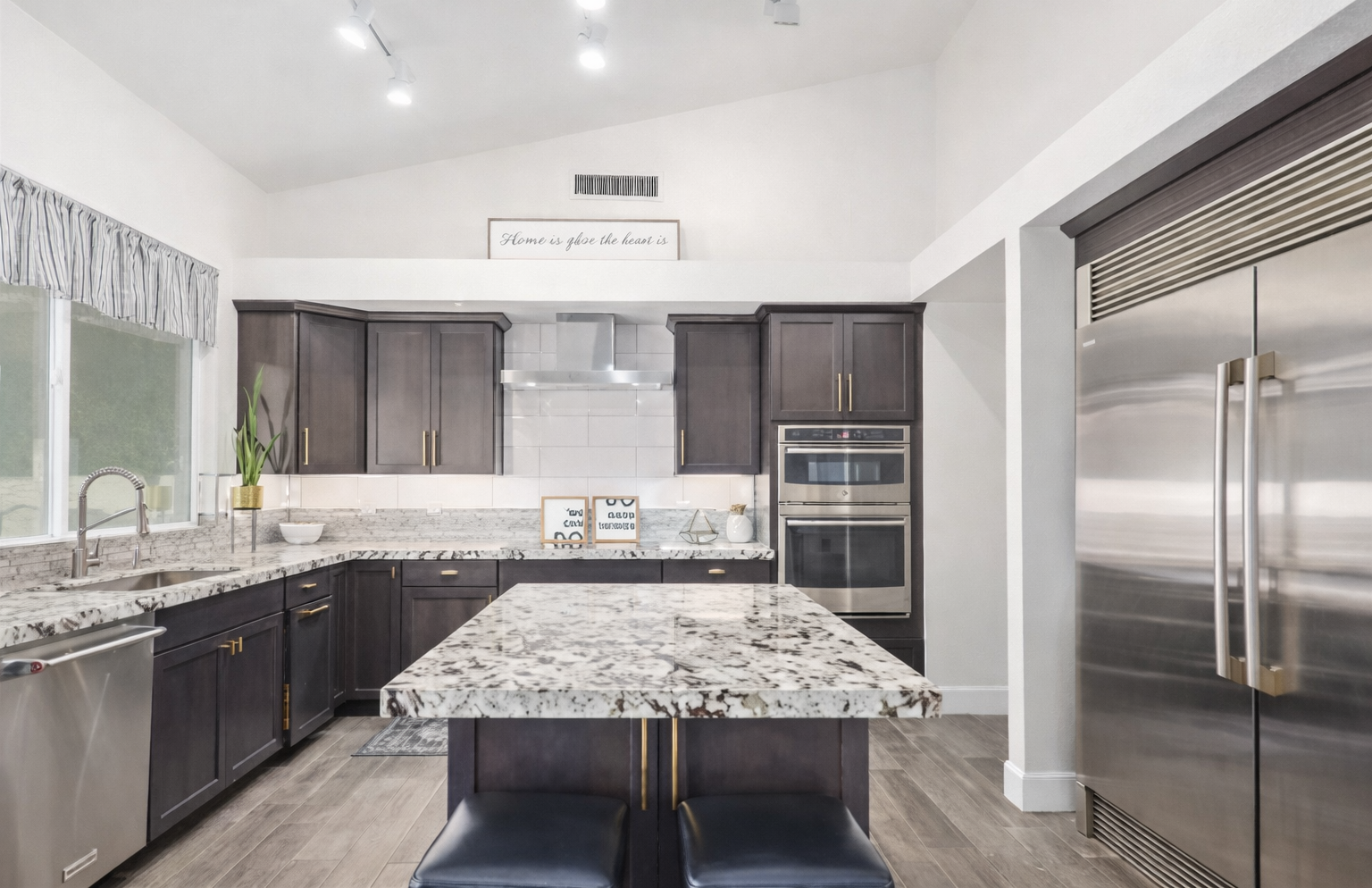 This chef-inspired kitchen offers high-end finishes, double ovens, and a huge island perfect for family meals and entertaining.