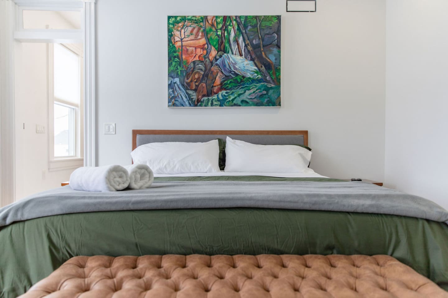 A cozy bedroom featuring a comfortable queen-sized bed, dressed in soft linens and placed as the focal point of the room, offering a perfect spot for rest and relaxation.