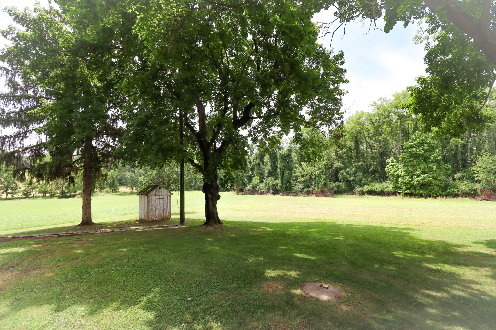 Enjoy the peaceful outdoor setting with a large open lawn, mature shade trees, and plenty of space to relax, play, or enjoy the fresh air