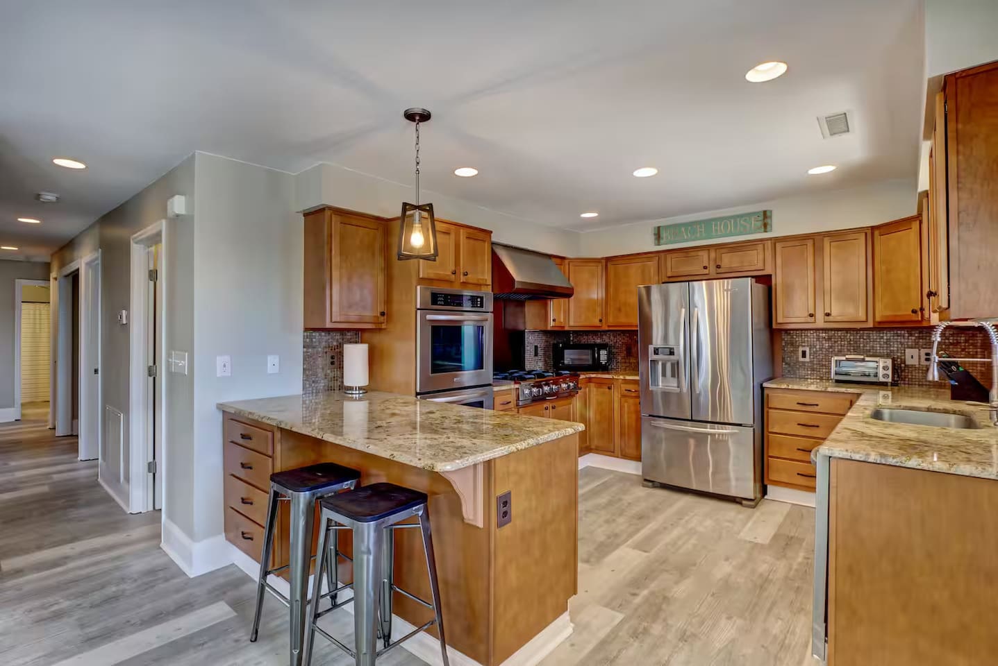Well stocked kitchen with stainless steel appliances.