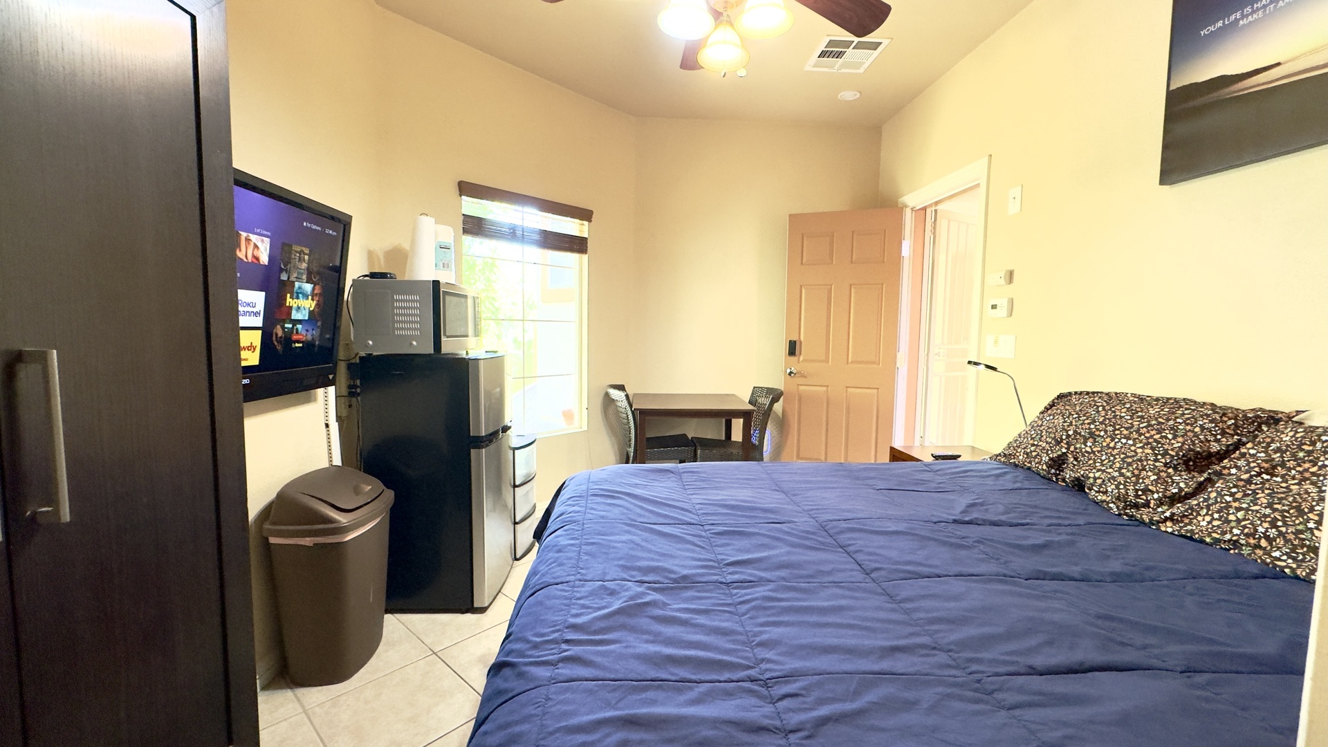 Cozy furnished studio — table, seating, and private entrance with smart lock