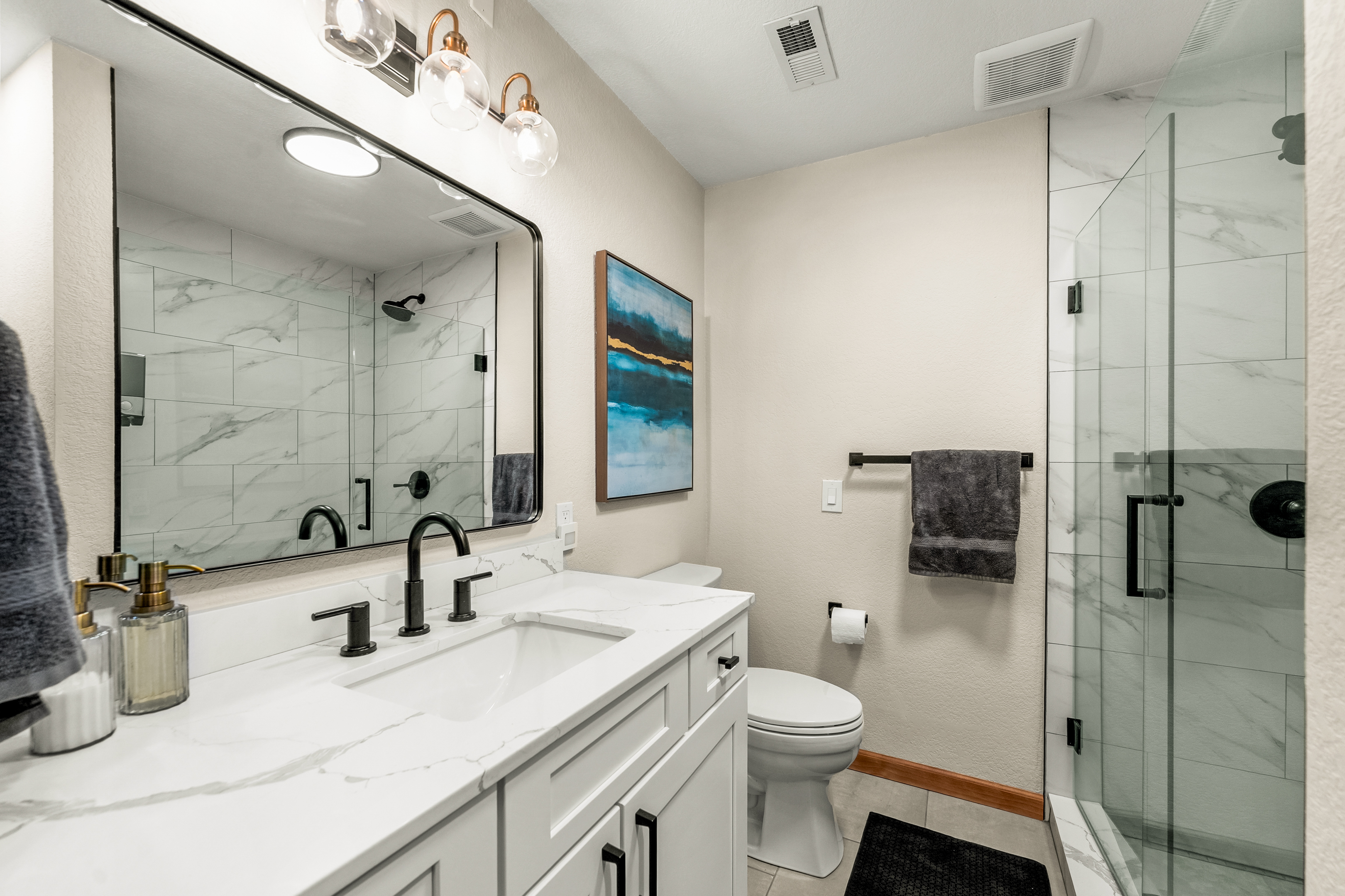 🚿✨ Spa-like lower-level ensuite bathroom with a sleek double vanity, modern lighting, and a glass walk-in shower—bright, clean, and ready for your refresh 🧼