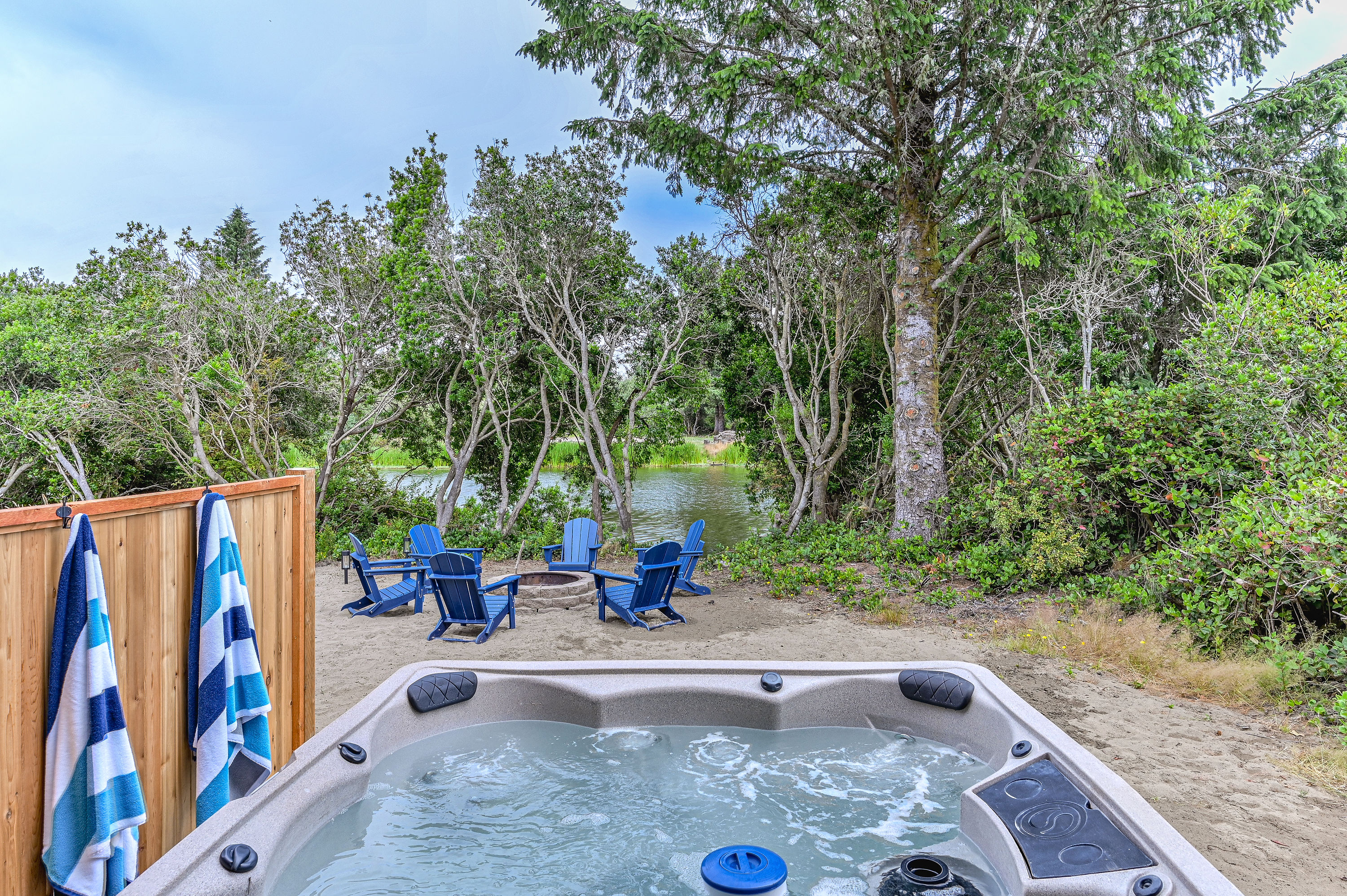 Sink into the bubbles and let your evening go quiet — the fire pit's already glowing just past the fence, waiting for whoever gets out of the hot tub first.