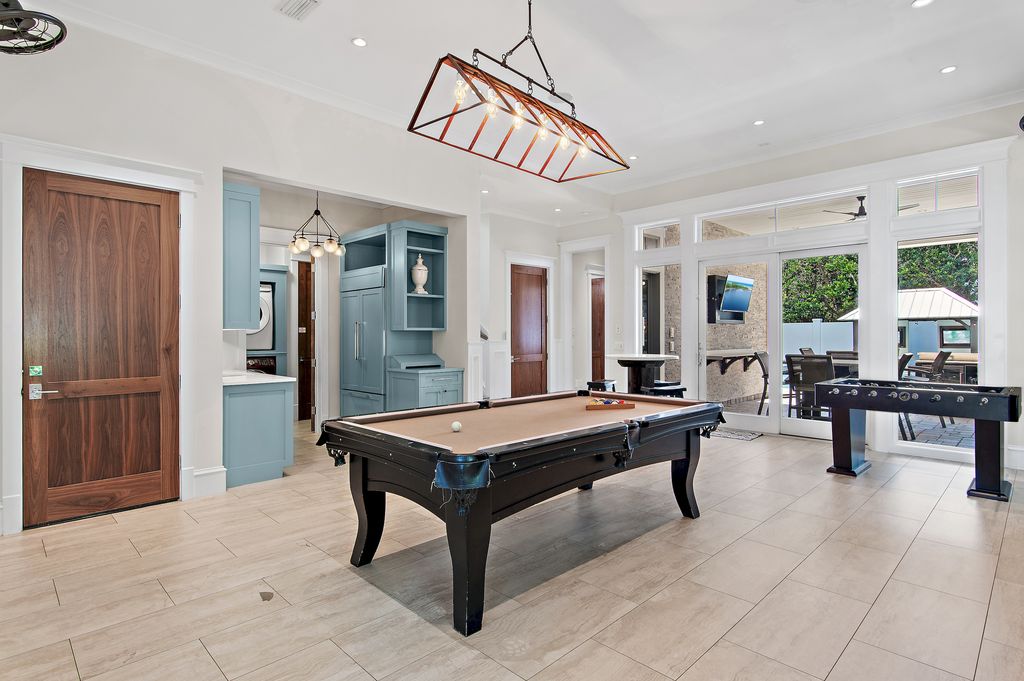 Game room with pool table, foosball, and direct poolside access