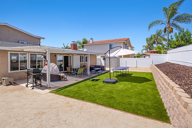 Spacious back yard with new grill and games