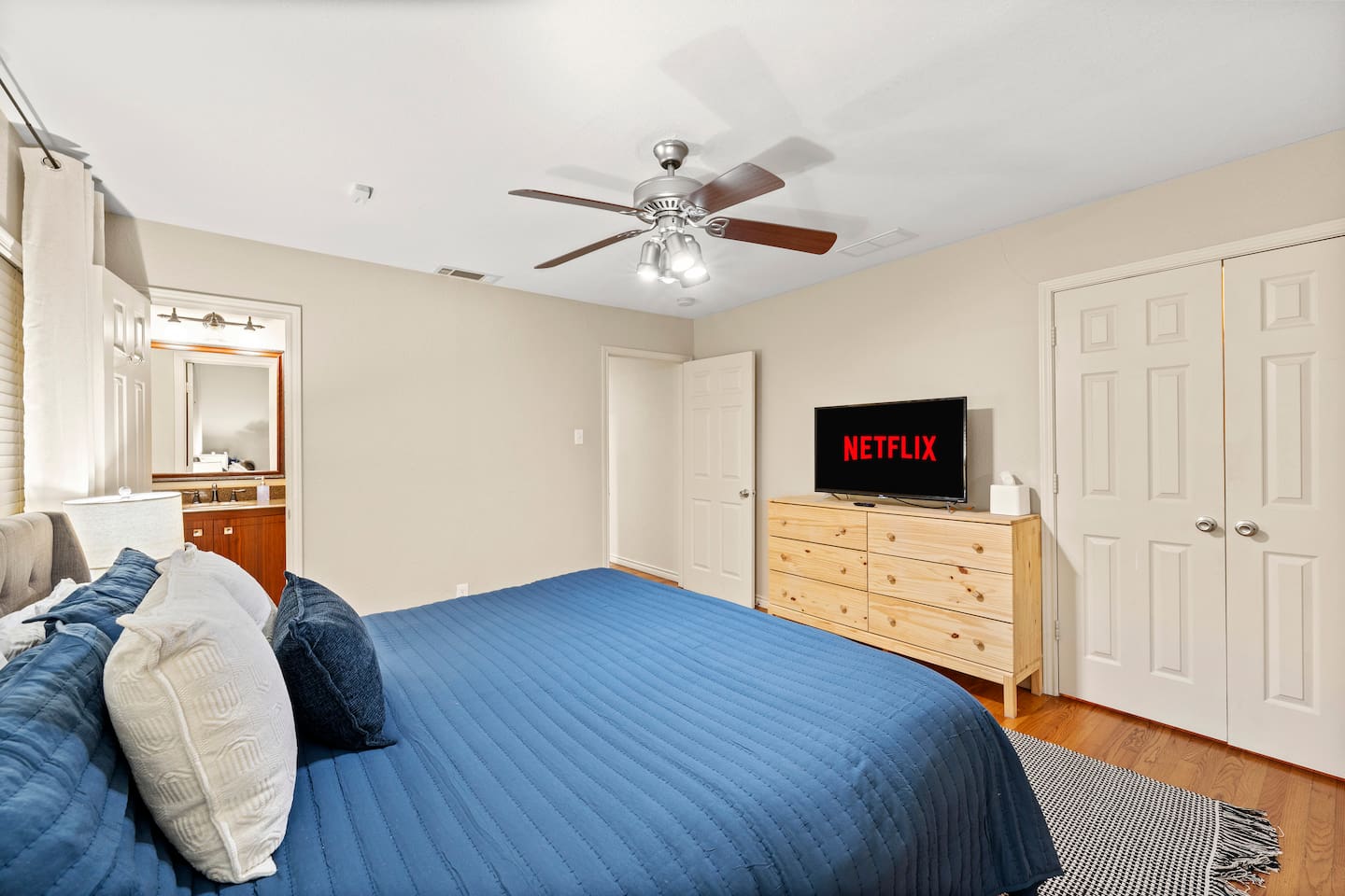 Unwind in a spacious king bed with layered pillows, blackout curtains, and bedside lighting for the perfect night’s rest.