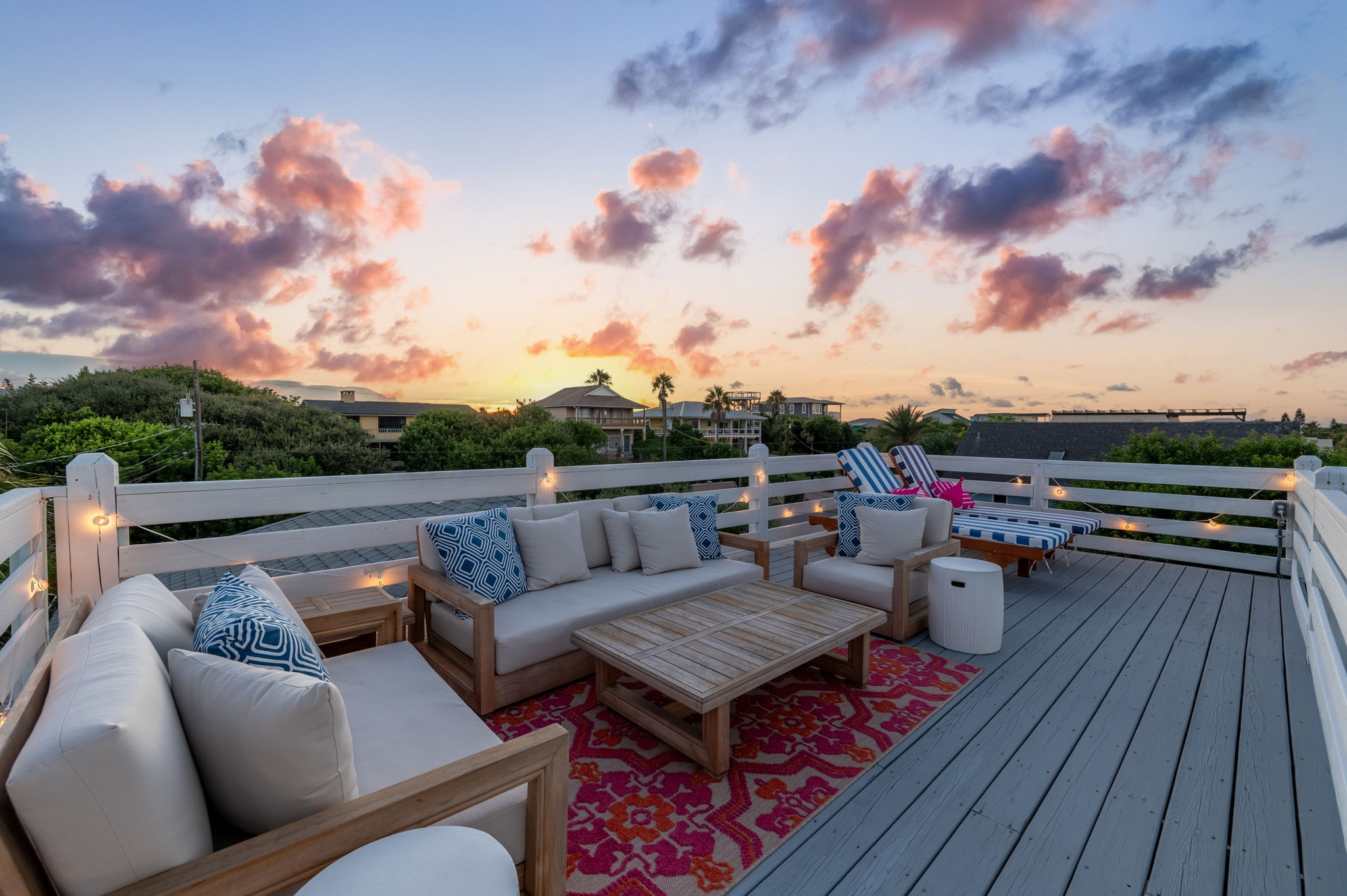 Welcome to the Eagle’s Nest deck at the top of the house! This spacious area features two striped lounge chairs and a cozy seating area with a coffee table and side tables—perfect for hanging out with a crowd or enjoying some quiet time with a view!