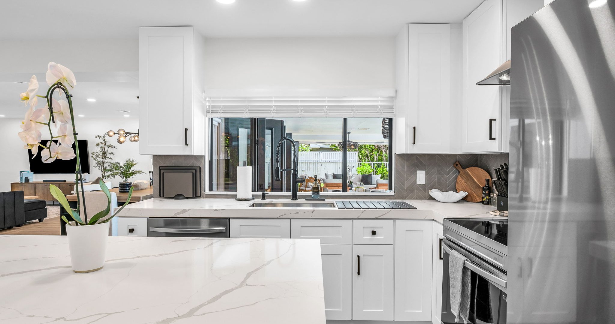 Bright and airy, this modern kitchen combines luxury finishes with everyday comfort. Enjoy the designer backsplash, expansive counter space, and seamless flow to the dining and living areas.