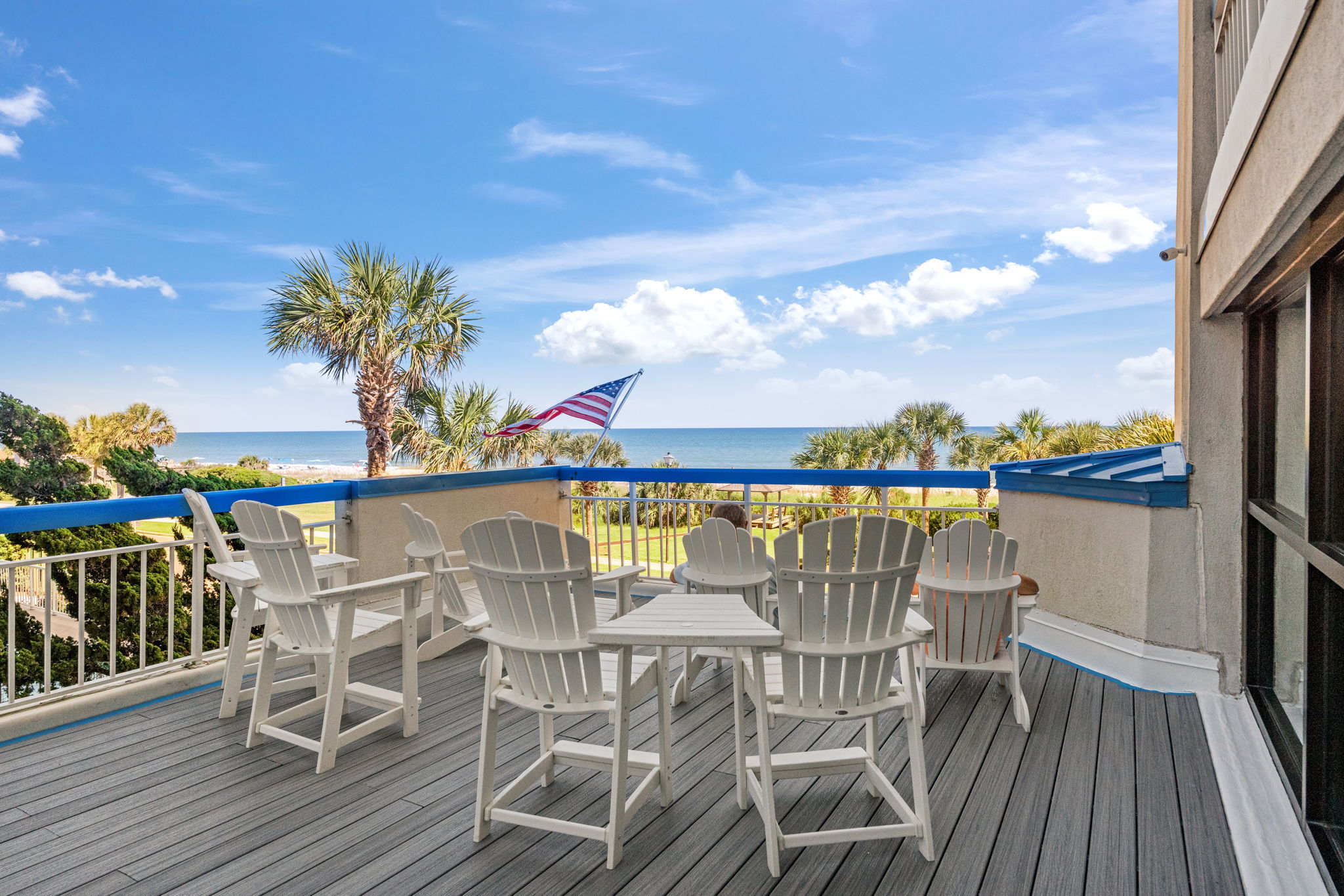 Resort sun deck with seating and ocean views