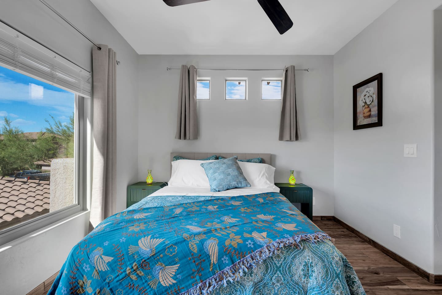 Luxurious queen bedroom with stunning mountain views, smart-TV, and work desk.