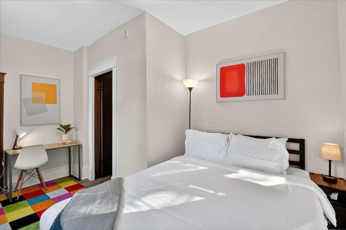 Queen-size bedroom with dedicated workspace.