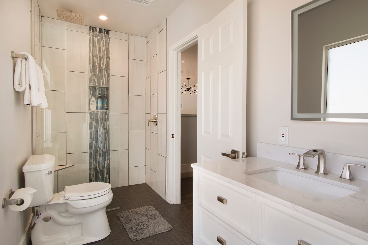 Guest bathroom off the living room (Laundry room attached)