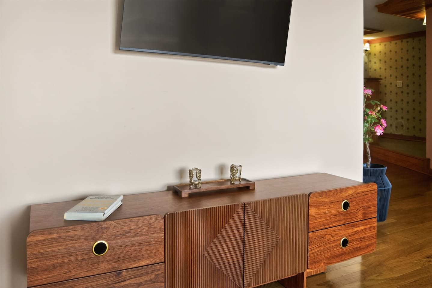 Warm wood console with clean lines and mid-century charm, styled with simple decor for a calm, inviting feel.