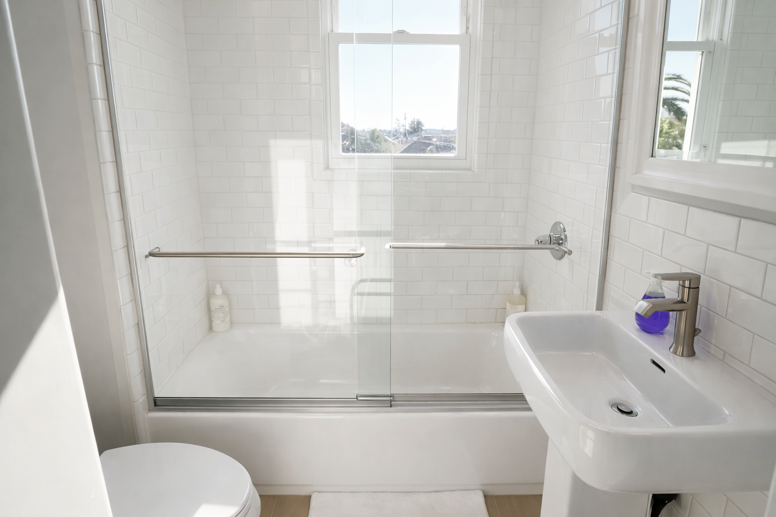 A clean and bright full bath featuring a subway-tiled tub/shower combo and modern fixtures.