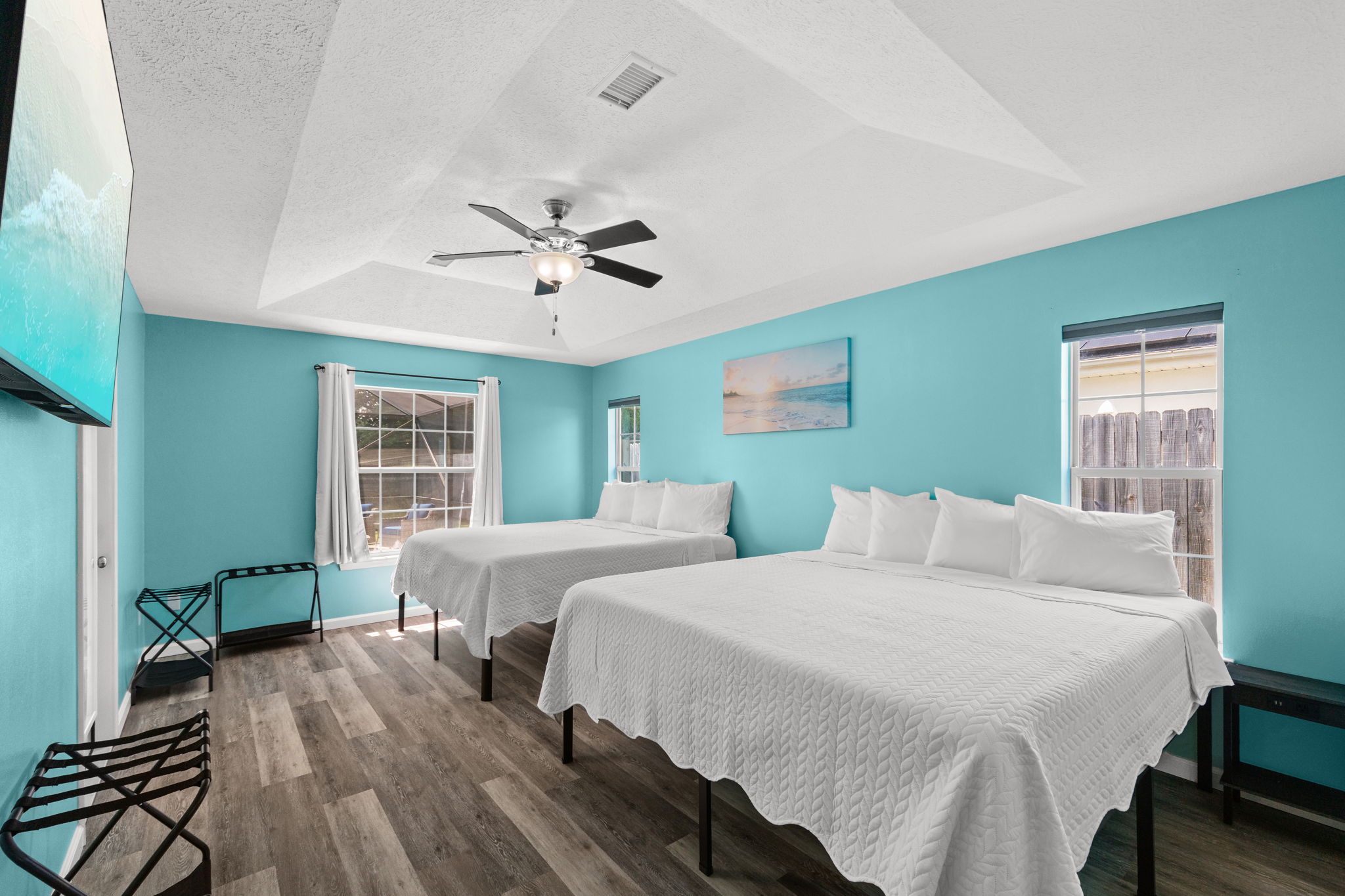 The ultimate private master suite for groups or families! This massive bedroom features two ultra-comfortable king-size beds, a private attached master bathroom, beautiful tray ceilings, coastal wall art, and a large 65-inch smart TV for movie nights. Best